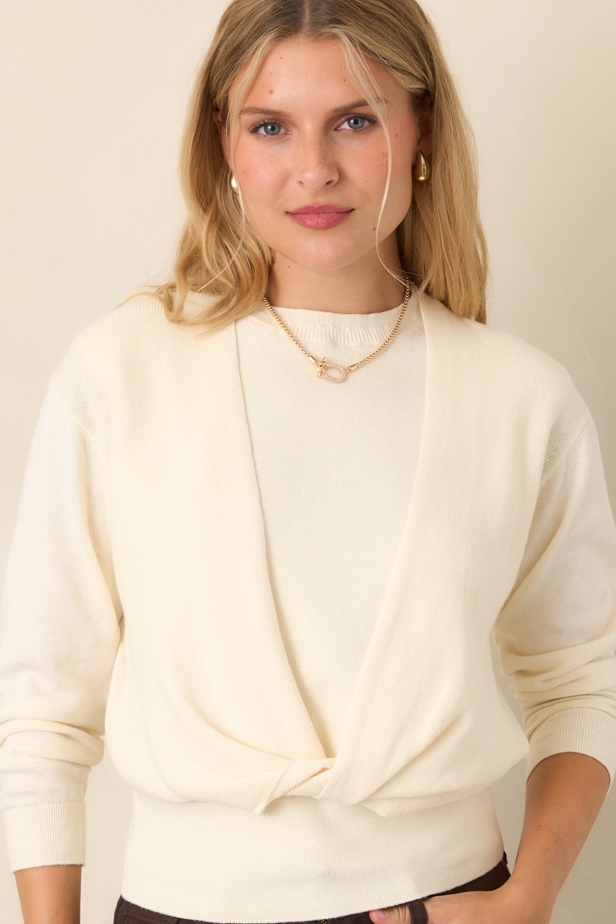 Cotton-cashmere knit top featuring a sleeveless crewneck base beneath a long-sleeve layer with a crossover front design.