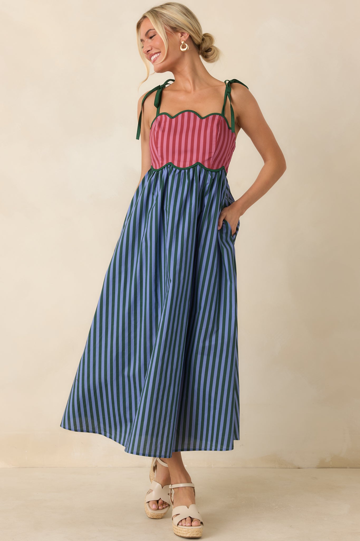 Crisp cotton midi dress with contrast piping, adjustable tie straps, and a charming gathered skirt silhouette.