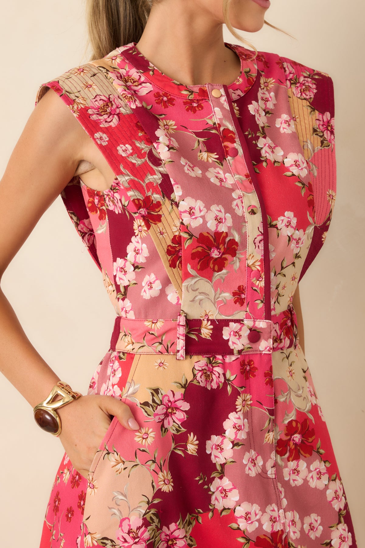 Close-up of the cotton denim’s pink, burgundy, peach, and cream floral print with delicate blossoms and leafy accents.