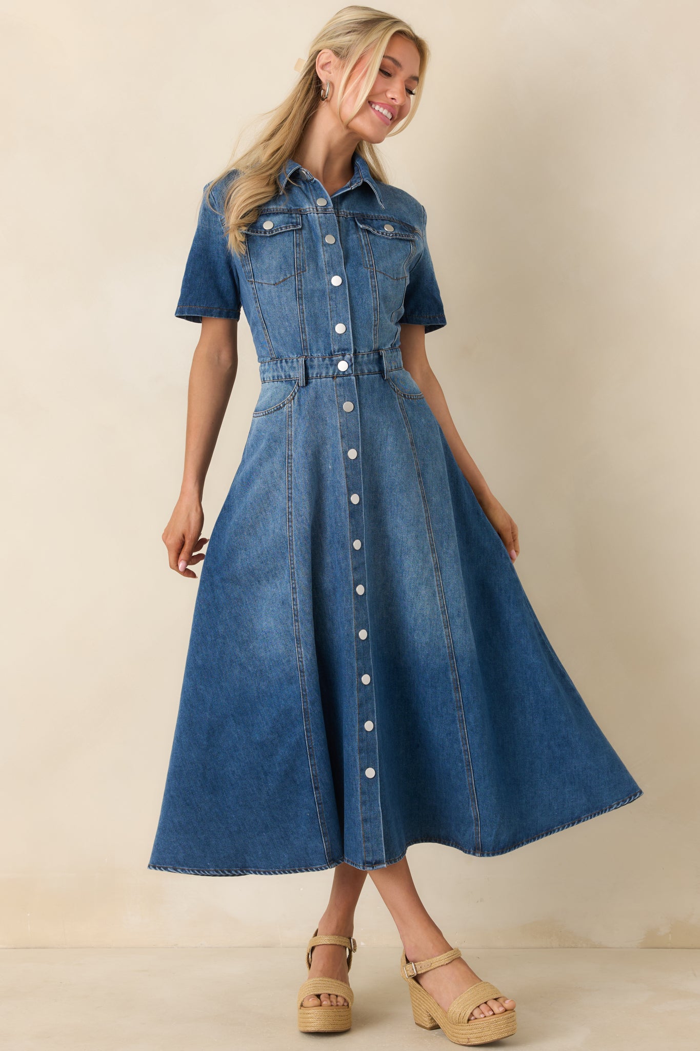 Cotton denim midi dress with a collared neckline, short sleeves, and a full snap-button front, featuring a fitted waist and structured seam detailing