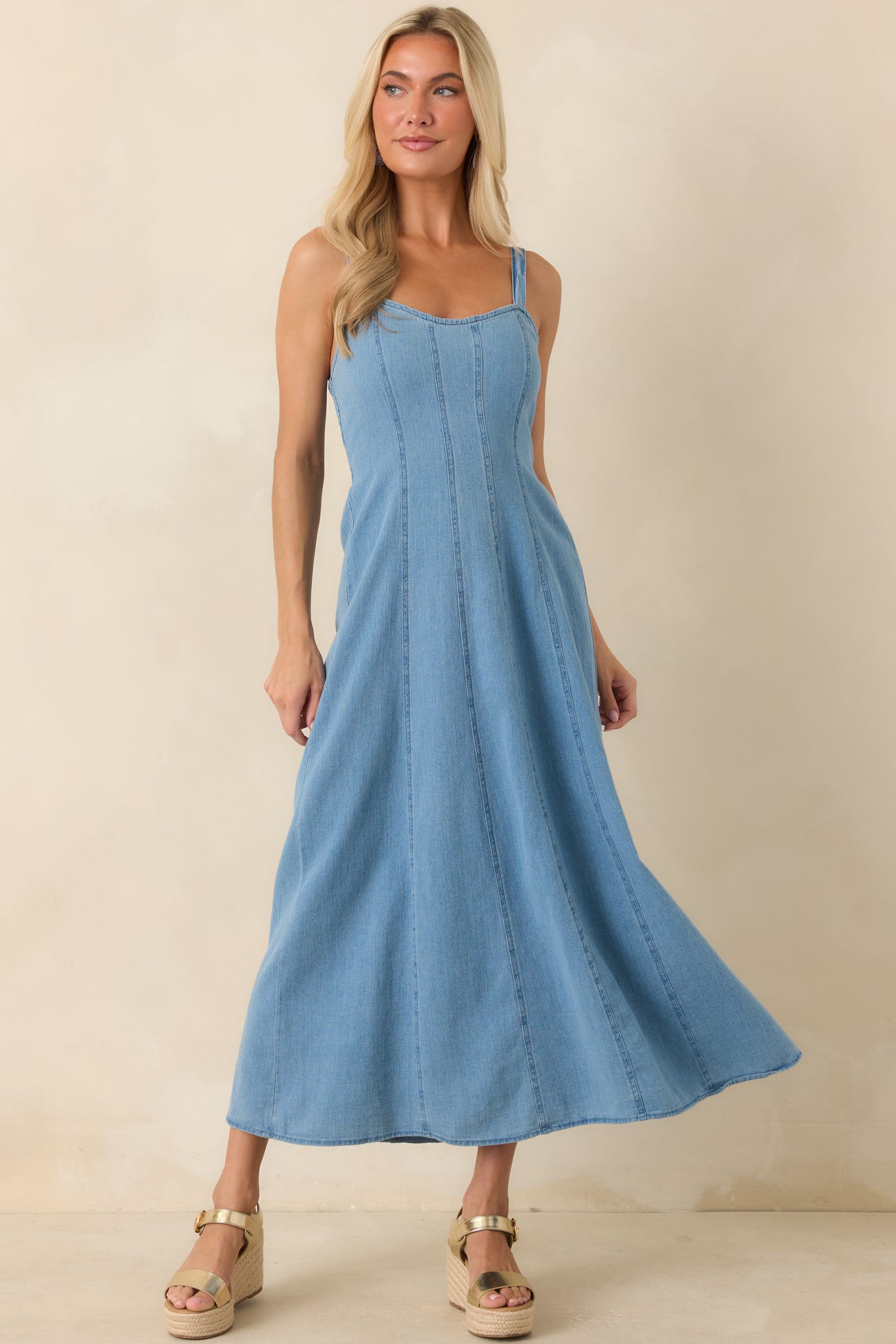 Cotton denim midi dress featuring a soft square neckline, adjustable spaghetti straps, and a fit-and-flare silhouette.