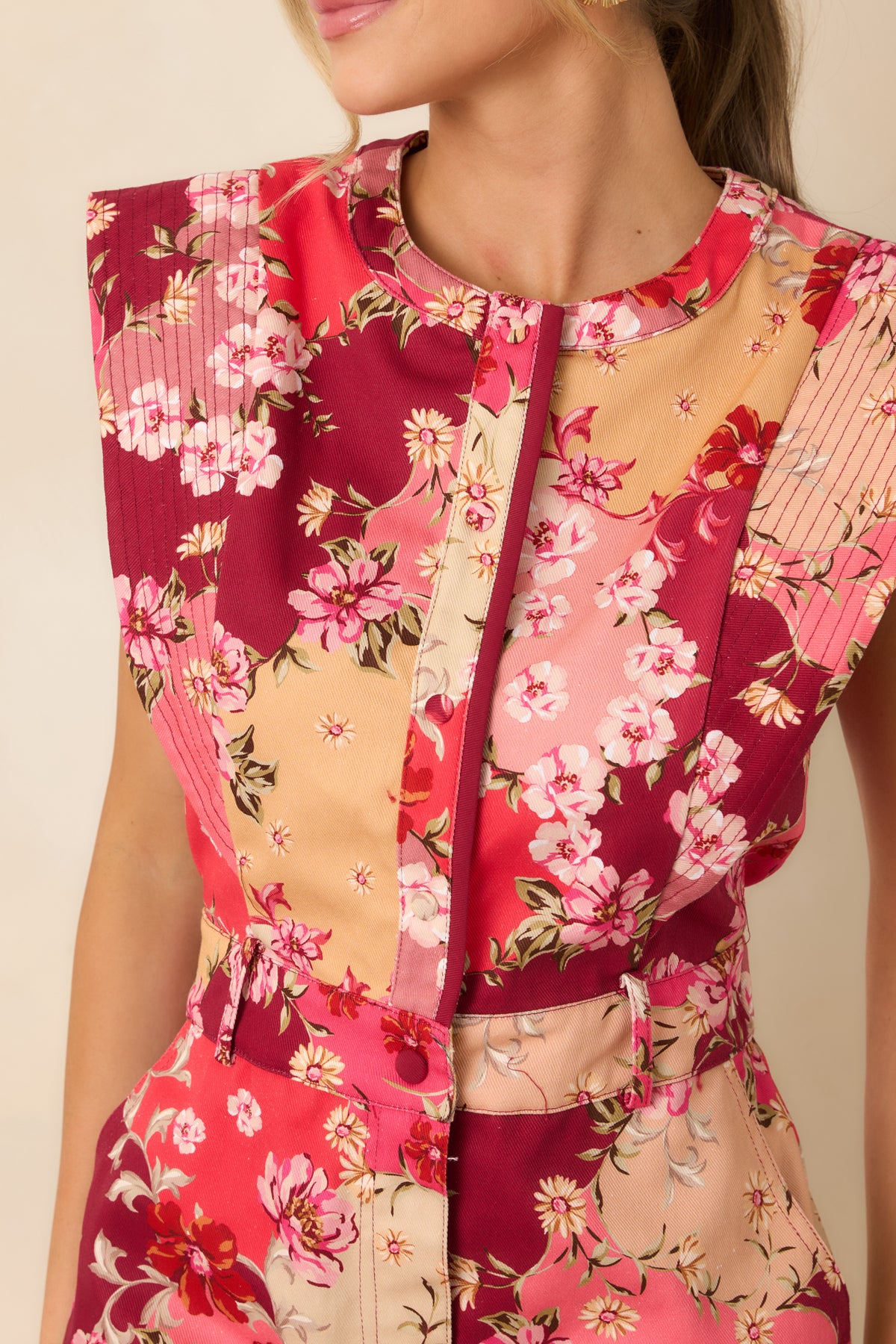 Close-up of the mini dress’s cotton denim print, featuring delicate pink and peach flowers with burgundy and cream accents.
