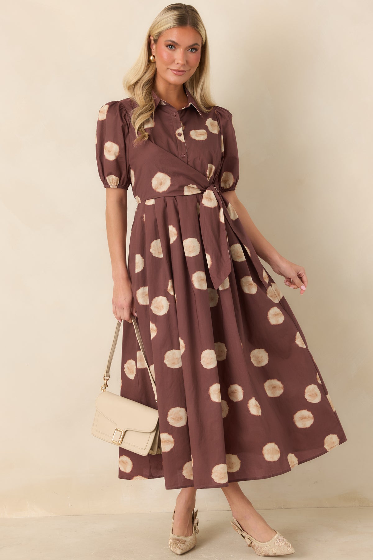 Cotton midi dress showcasing the softly blurred dot pattern and short puff sleeves.