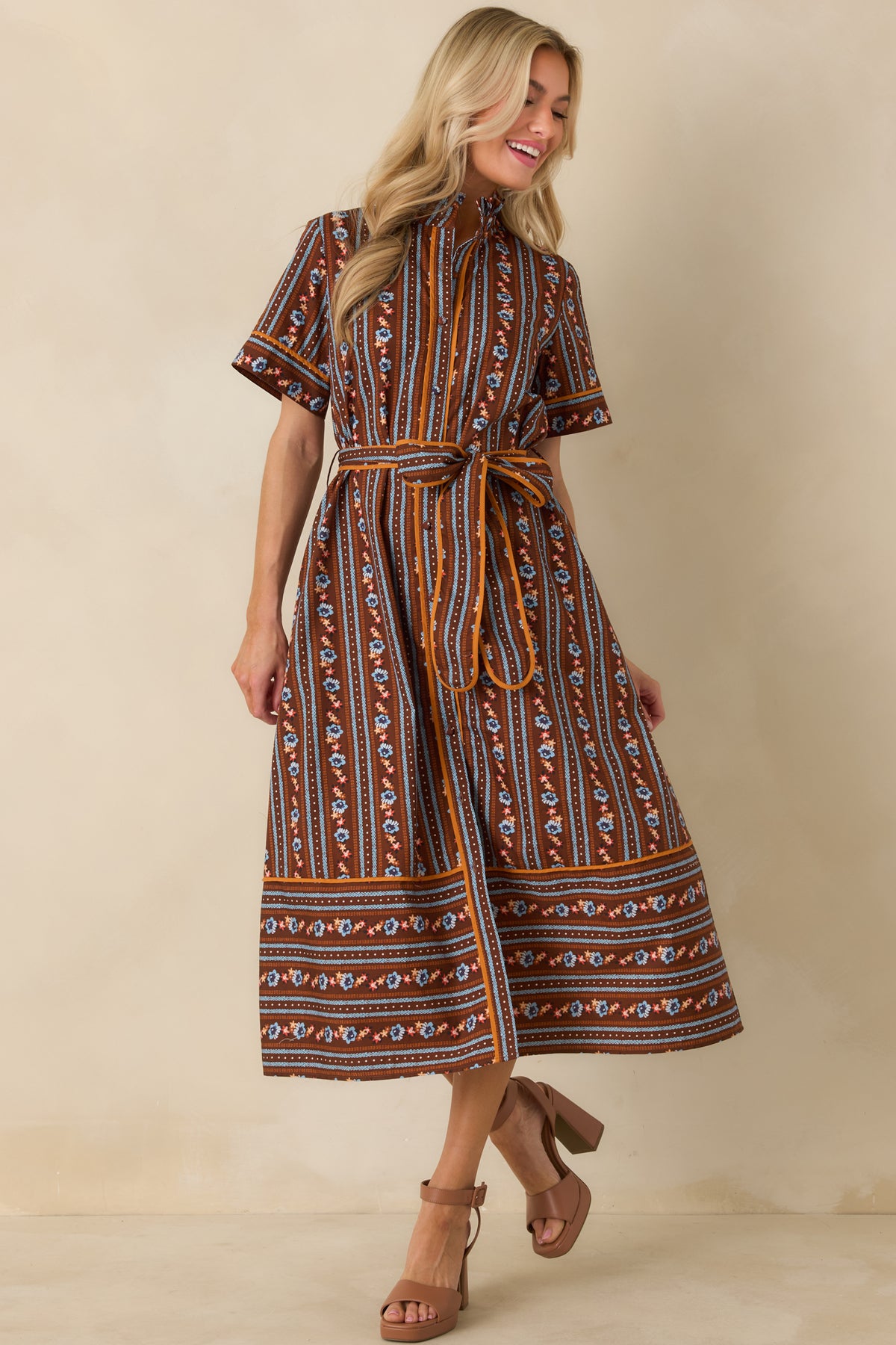 Cotton dress featuring contrasting border details, a classic A-line silhouette, and colorful floral and patterned stripes.
