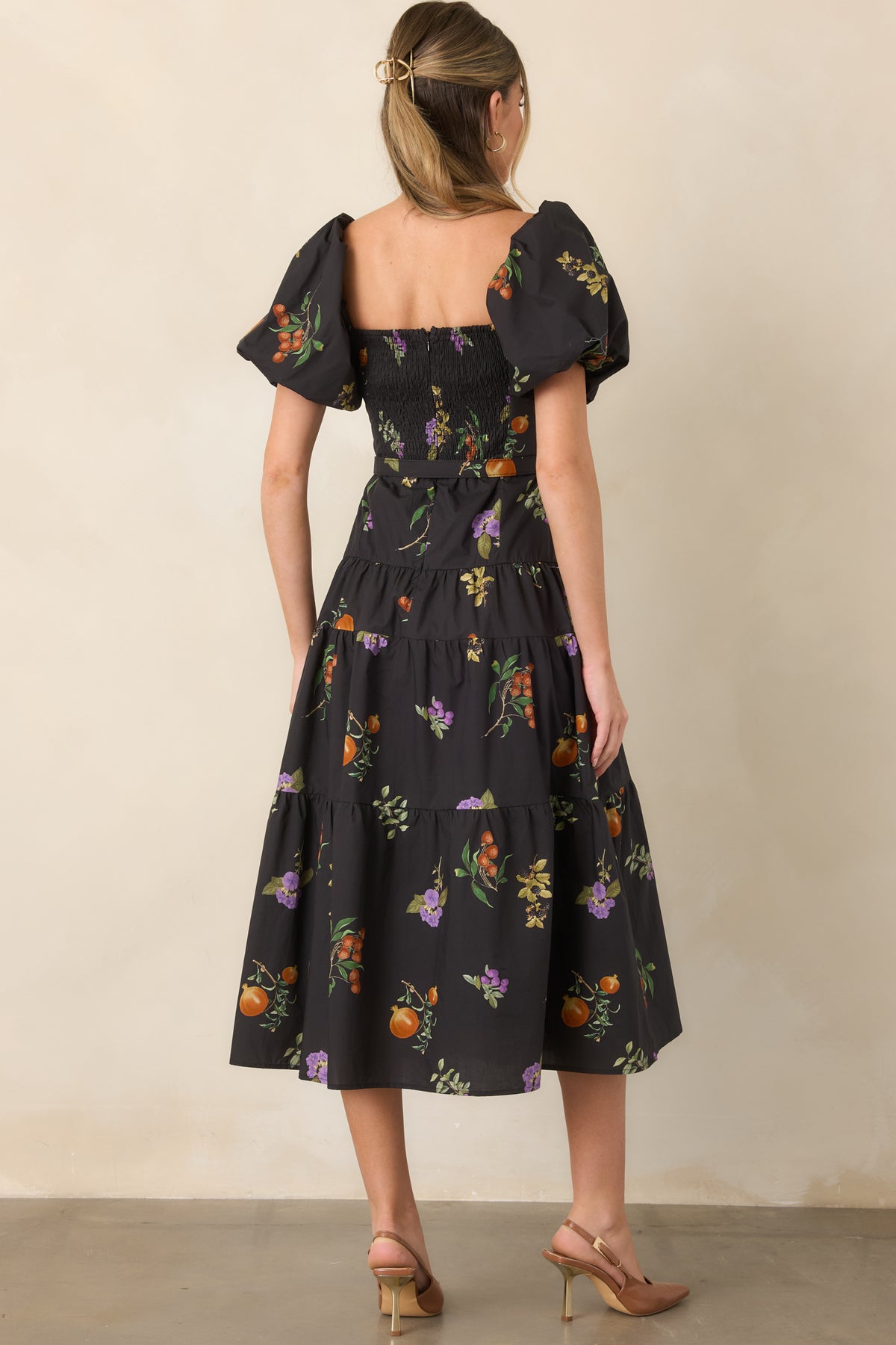 Rear of the cotton dress showcasing the smocked back, concealed zipper, puff sleeves, and defined waist.