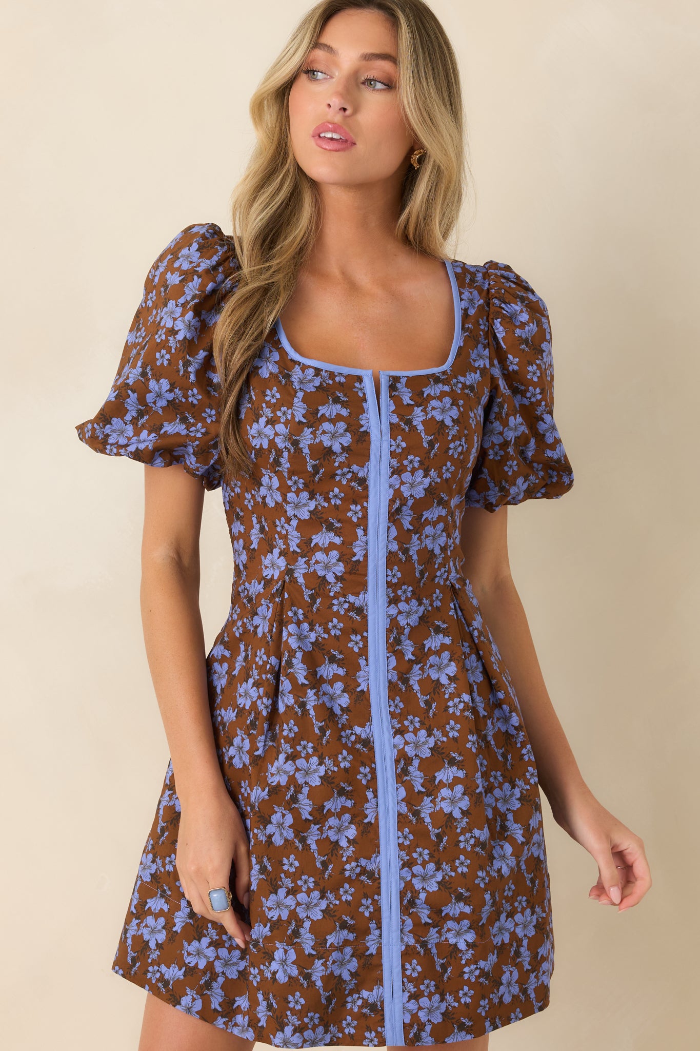 Detailed view of the cotton fabric showcasing the puff sleeves and subtle pleating that defines the waist.