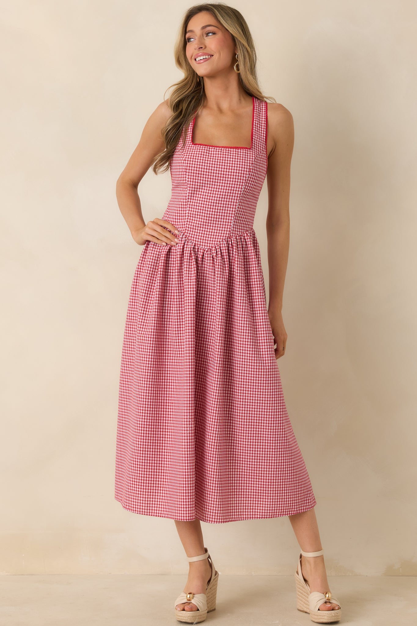 Cotton dress with structured bodice, wide straps, and softly gathered skirt.
