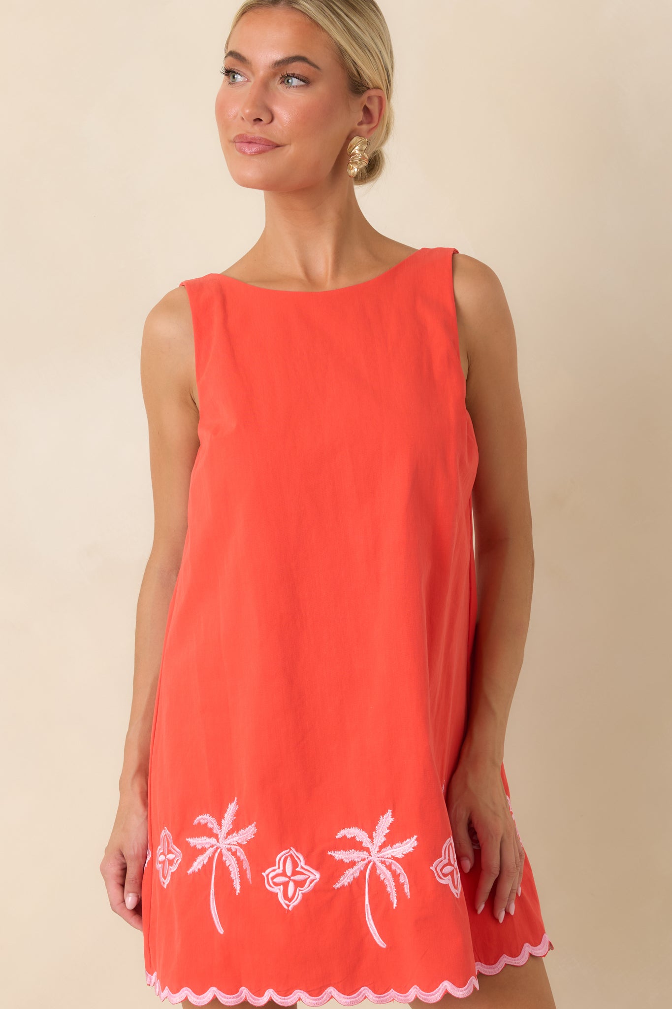 Soft cotton fabric showcases colorful embroidery and a relaxed silhouette designed for warm-weather wear.