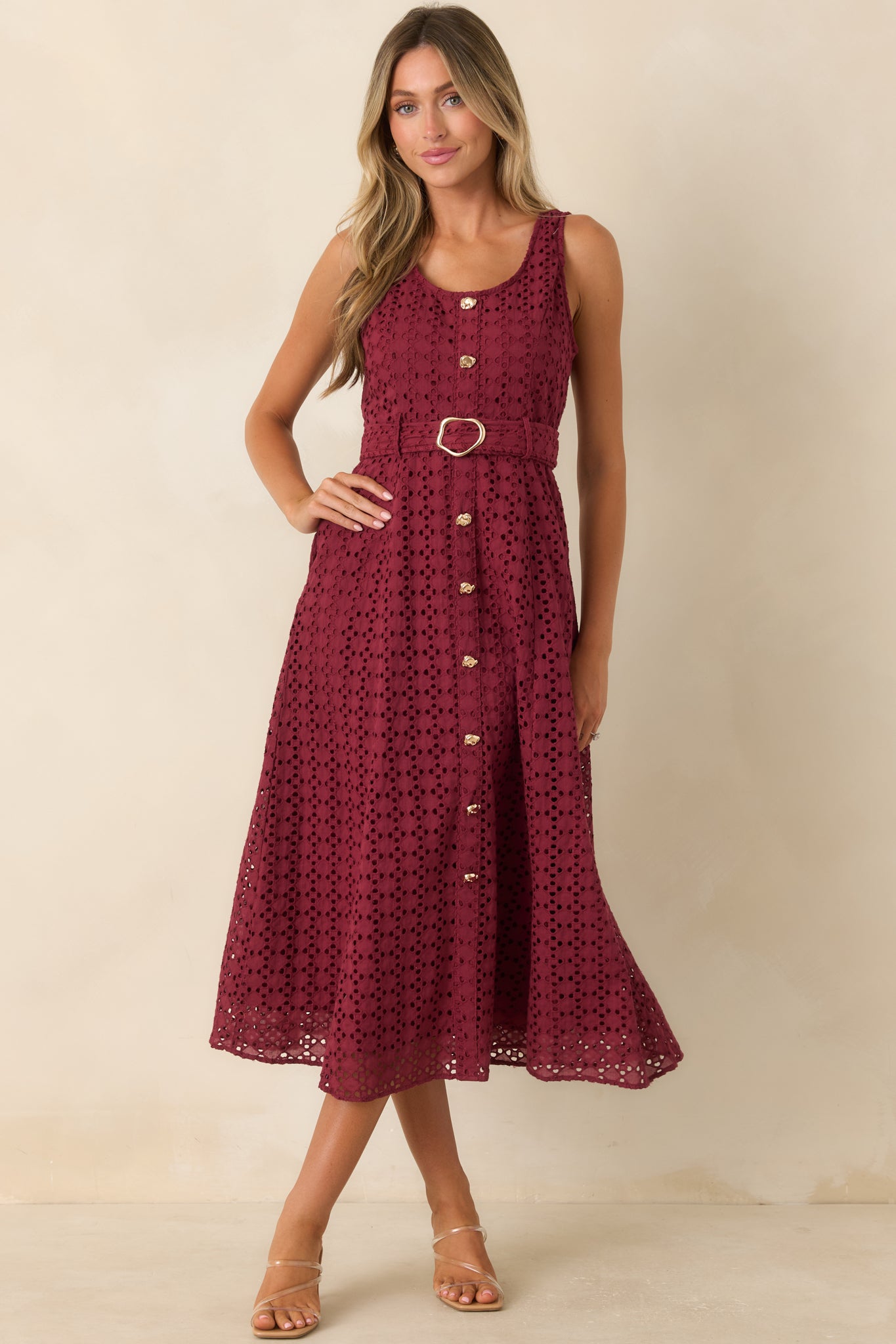 Cotton eyelet midi dress in deep burgundy featuring a feminine waist tie, textured embroidery, and functional side pockets.