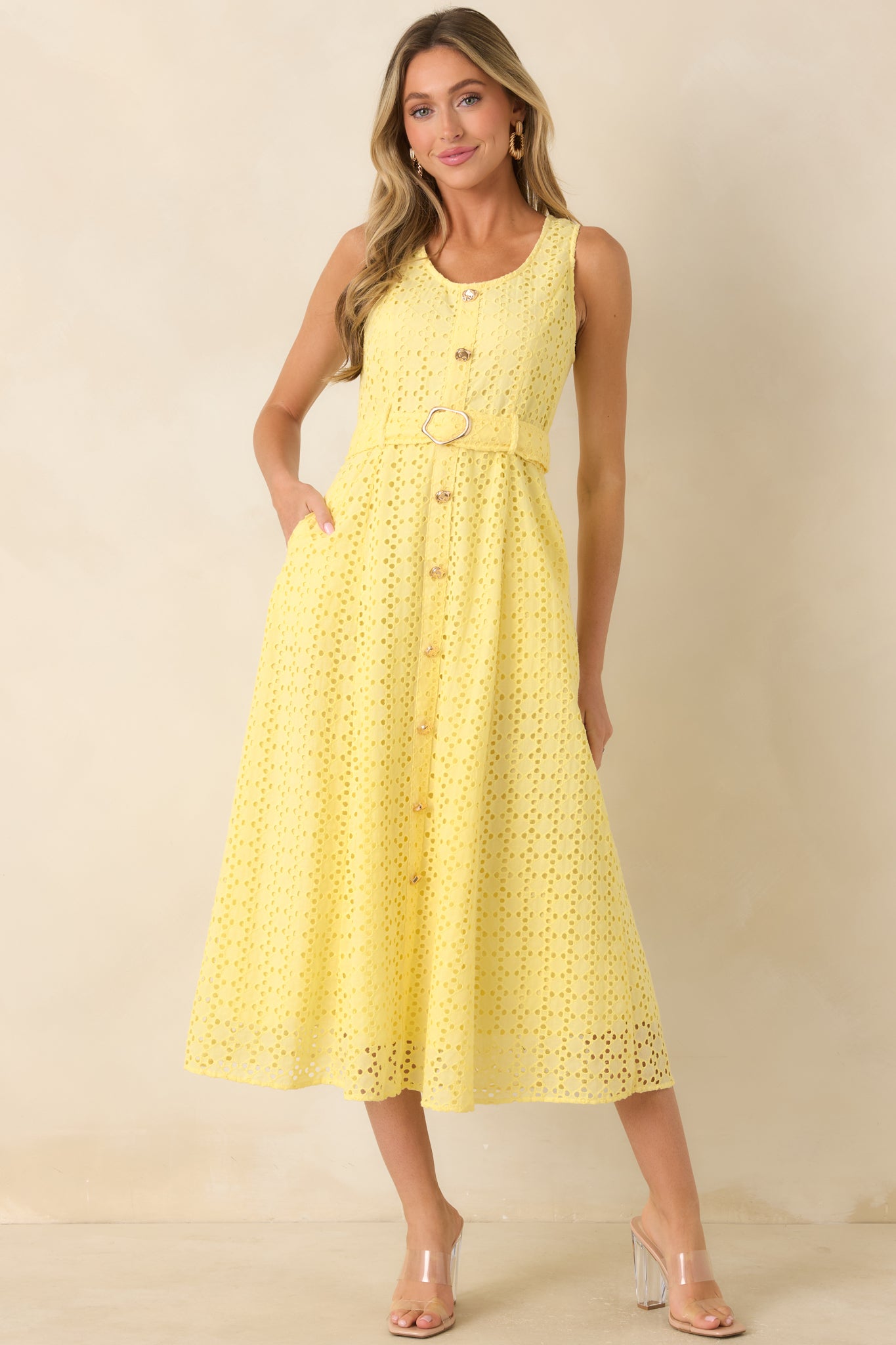 Cotton eyelet midi dress featuring a sleeveless silhouette, removable waist belt, and fully lined construction.