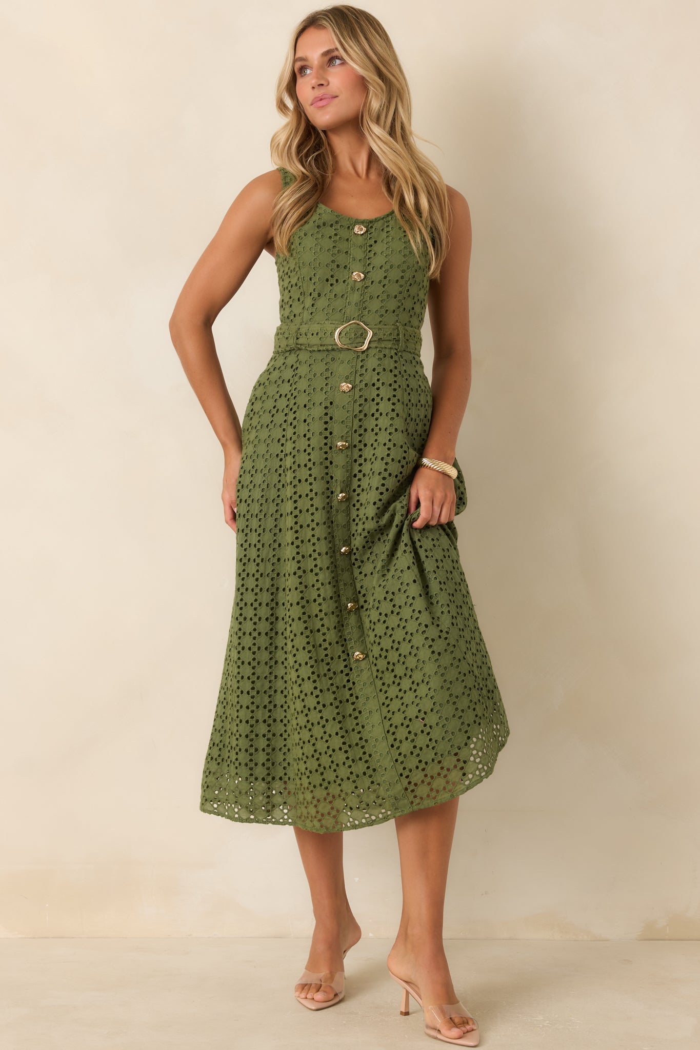 Breathable cotton midi dress designed with allover eyelet embroidery, a flattering removable belt, faux button front detailing, and a sleeveless fit.