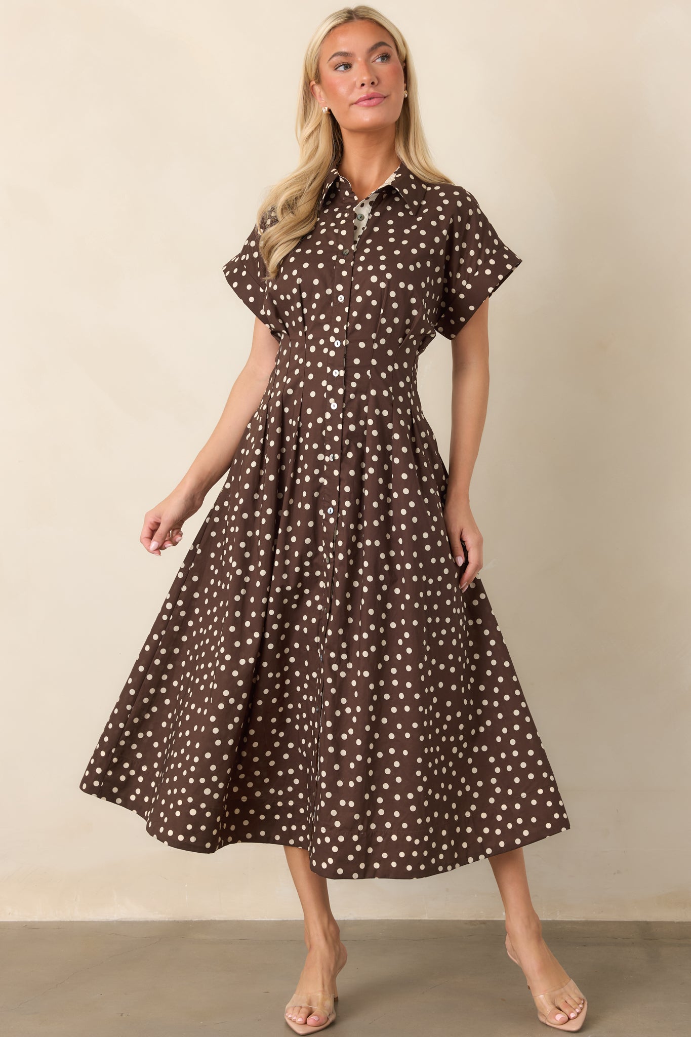 Cotton fit-and-flare midi dress with a collared neckline, full button front, short sleeves, tailored waist seams, and flowing skirt with side pockets.