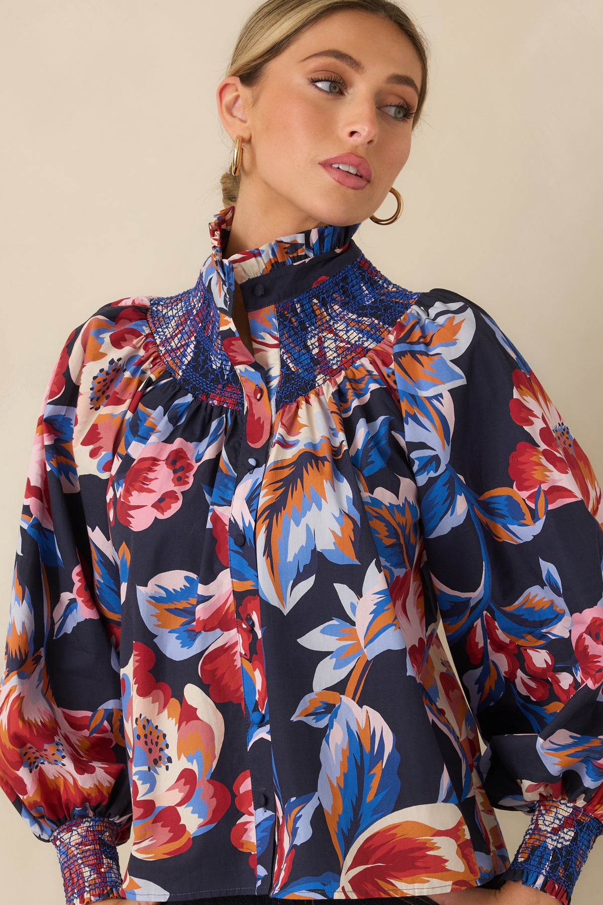 Cotton floral top showcasing the colorful oversized blooms, relaxed shape, and detailed smocked neckline yoke.
