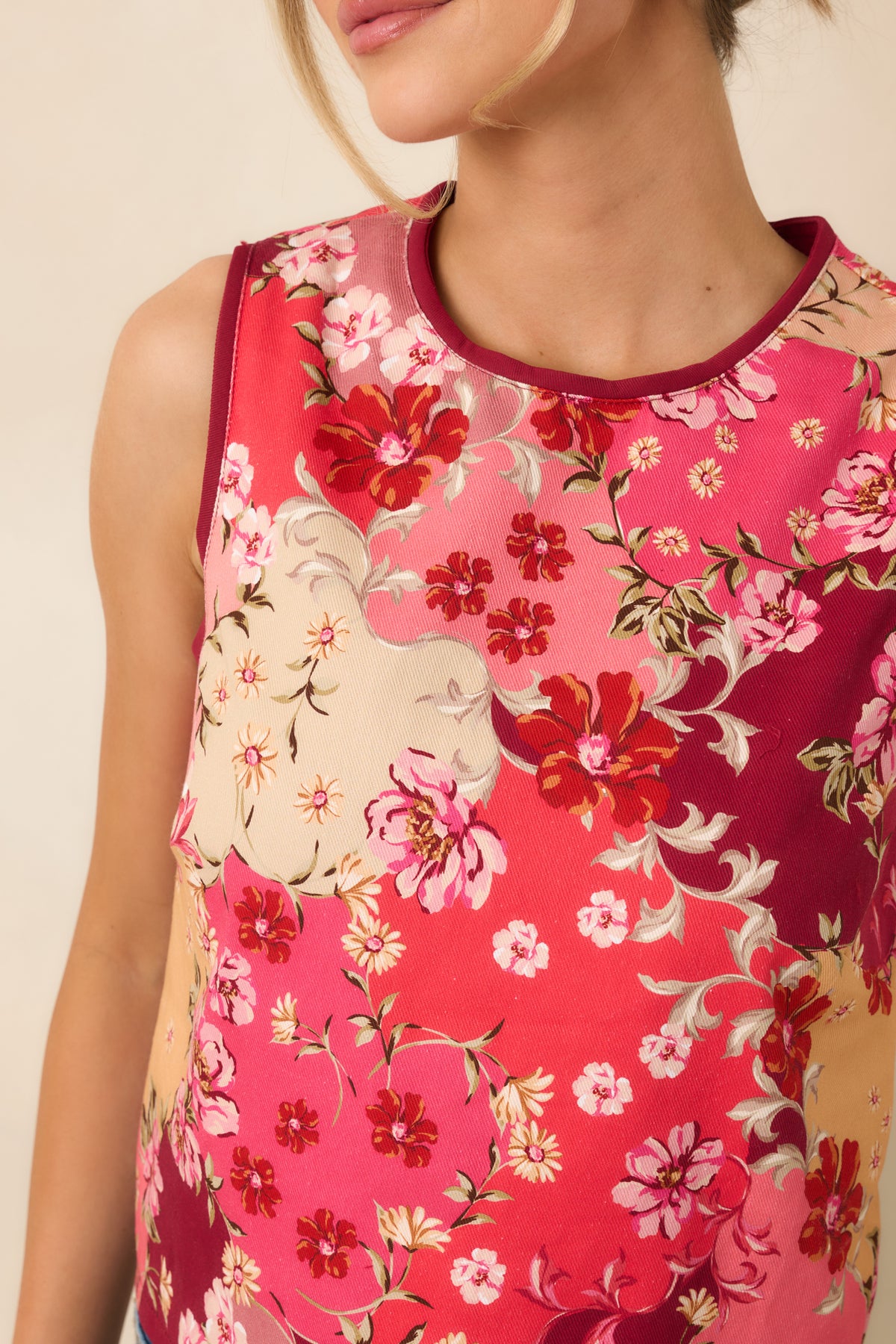 Close-up of the cotton top’s pink and peach blossoms, burgundy flowers, green foliage, and contrasting trim.