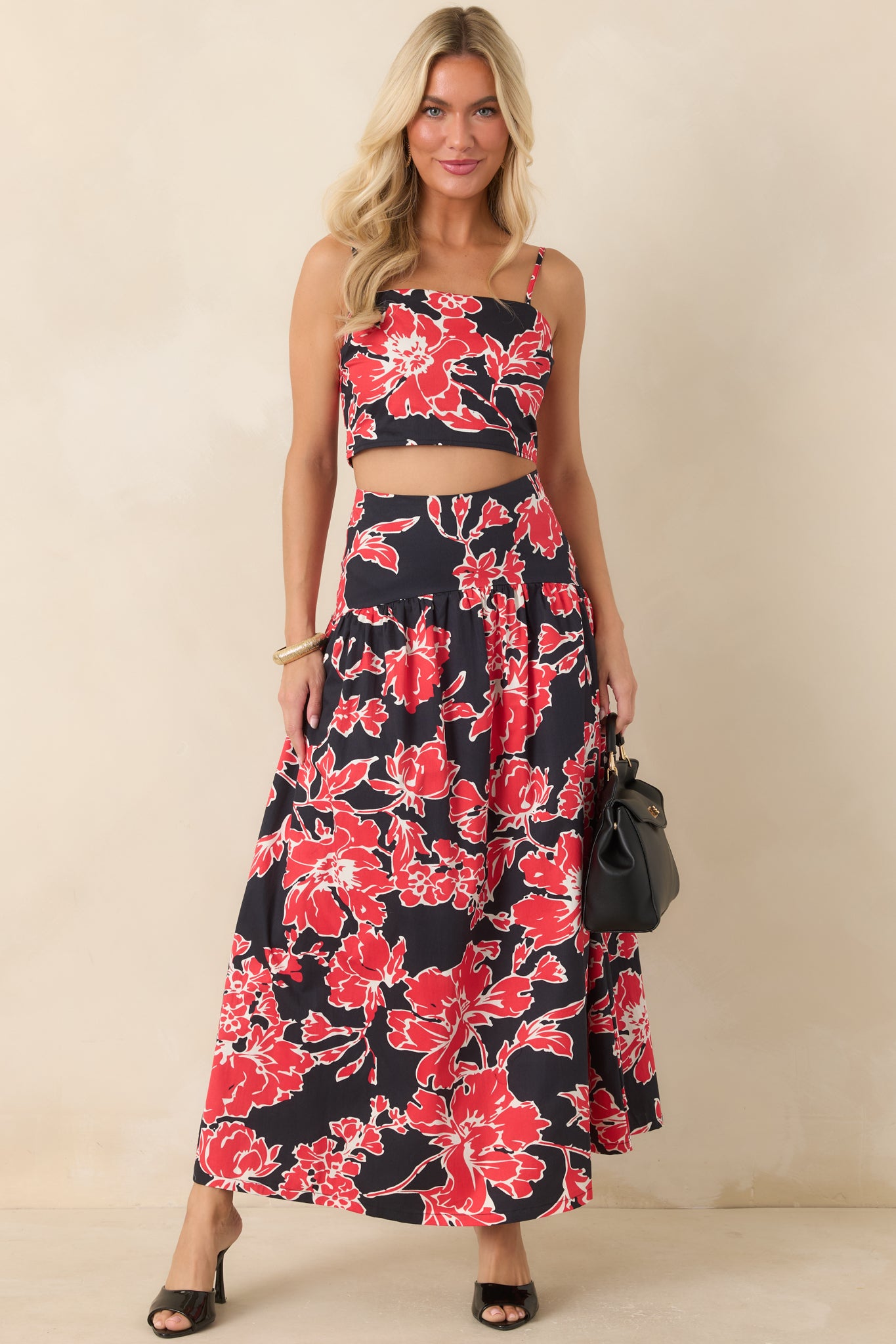 Cotton floral top showcasing a cropped silhouette, smocked back panel, and vibrant red blooms.