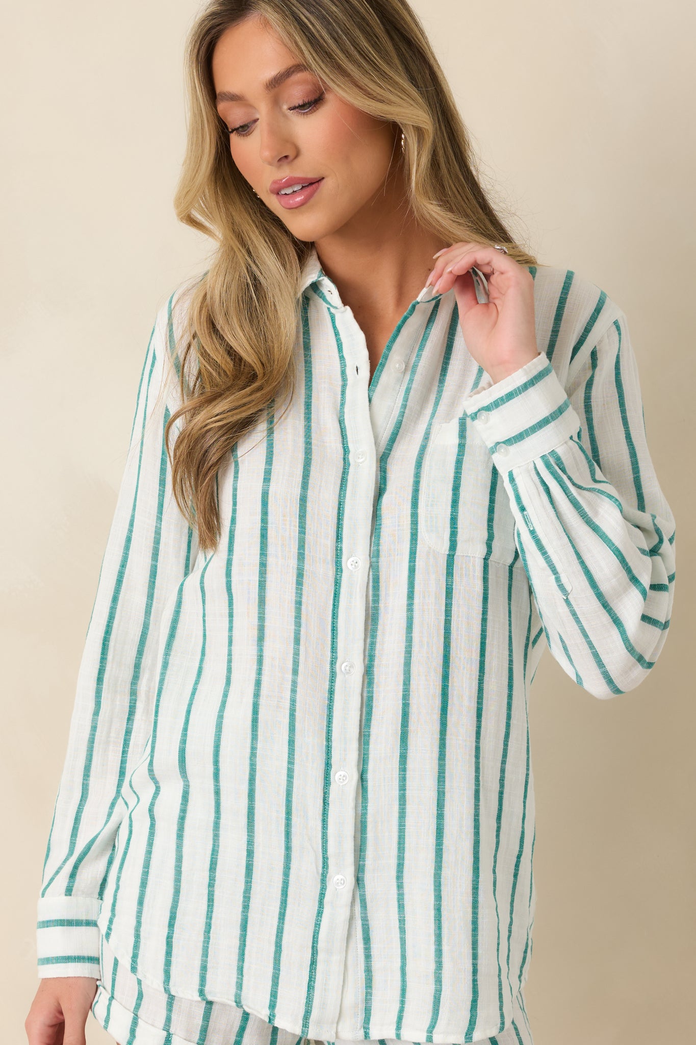 Closer view of the breathable cotton gauze fabric, button-front closure, and subtle textured finish of the striped shirt.