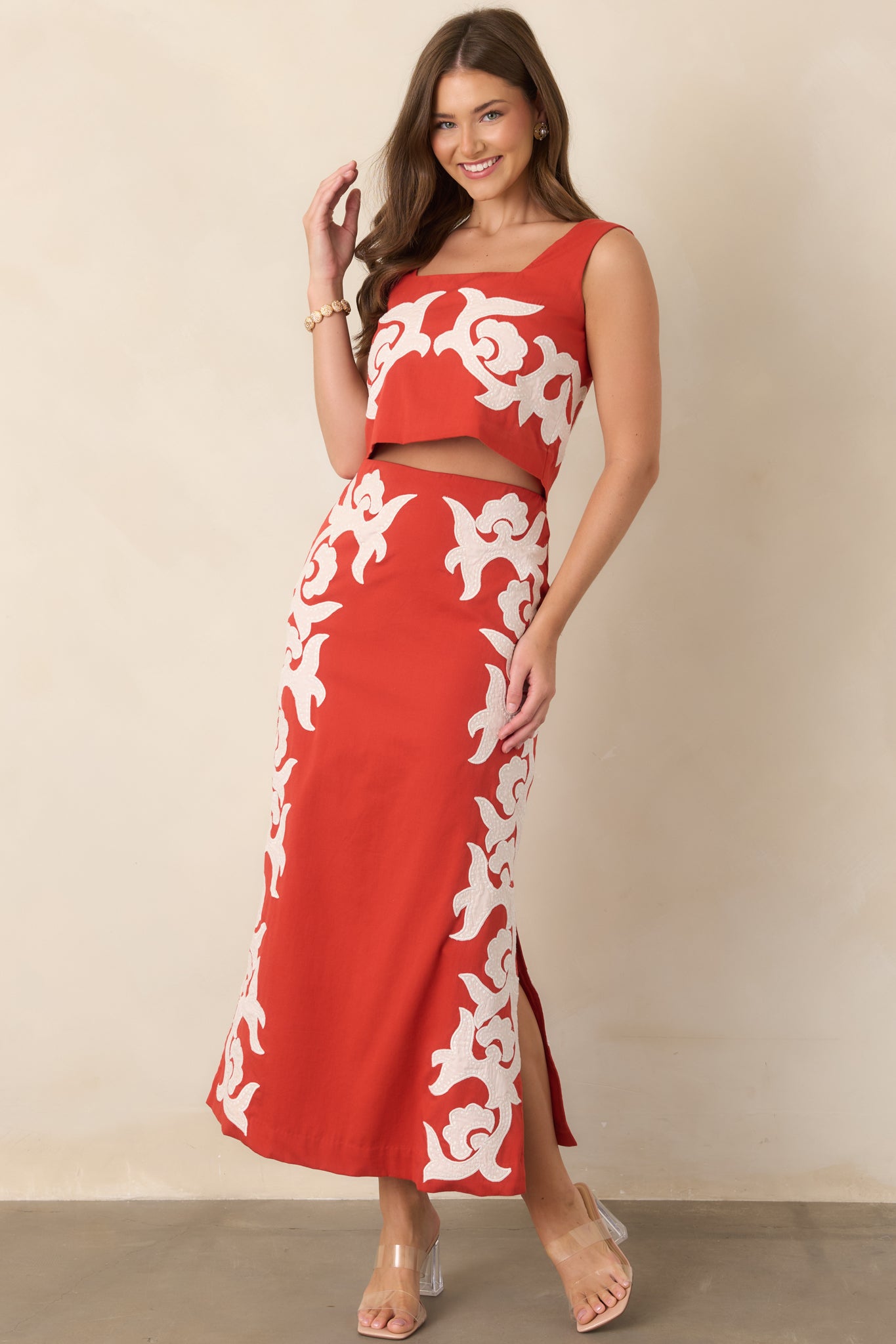100% cotton skirt featuring striking ivory appliqué accents, a long midi length, and a streamlined straight shape.