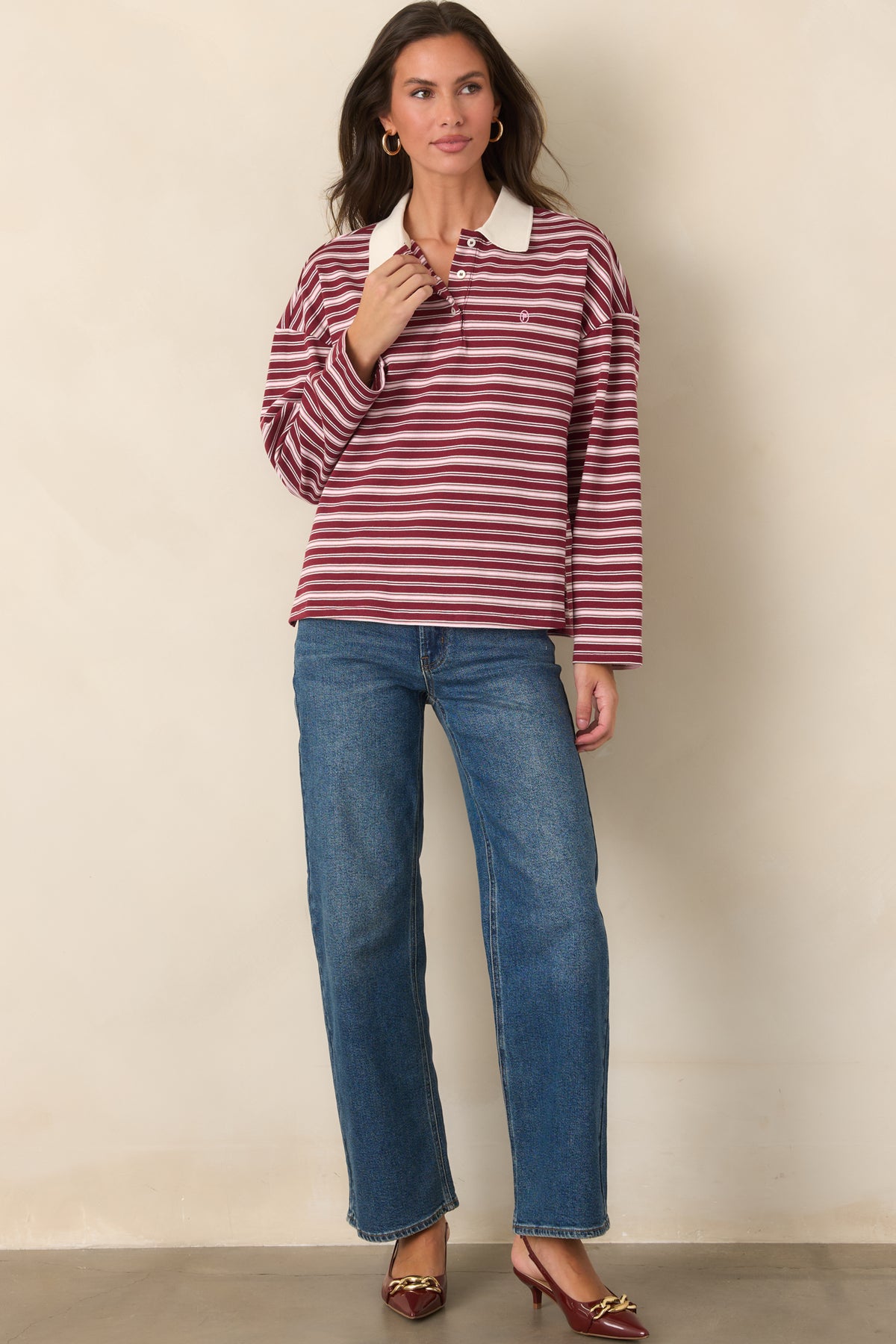 Cotton top with ivory stripes, a contrasting point collar, partial button closure, and petite embroidered logo.