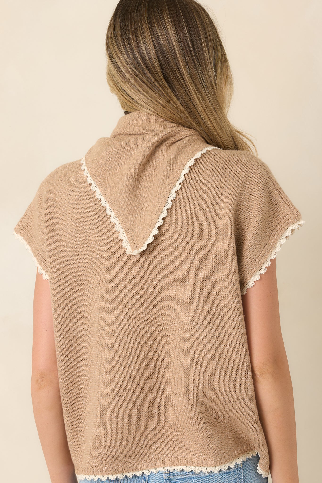 Rear view of the cotton knit top featuring a relaxed boxy silhouette, short sleeves, ivory trim, and a clean back design.