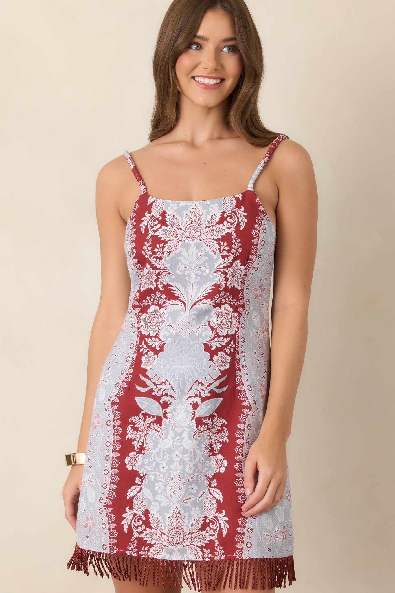 Fringe trim accents the hem of the cotton-linen mini dress, adding texture and playful movement to the silhouette.