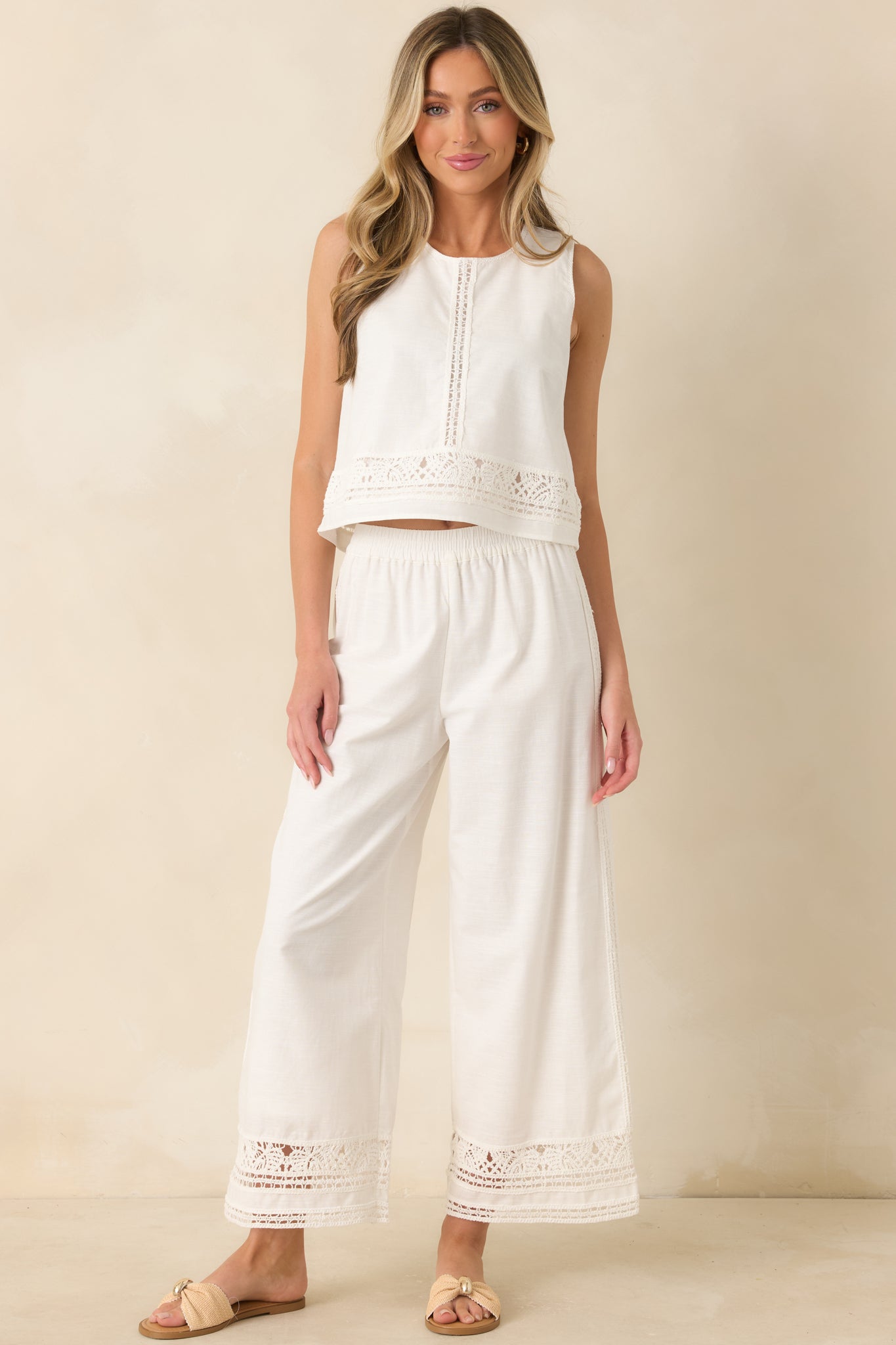 Lightweight cotton-linen blend pants with a comfortable elastic waist and elegant lace trim running down the outer seams.