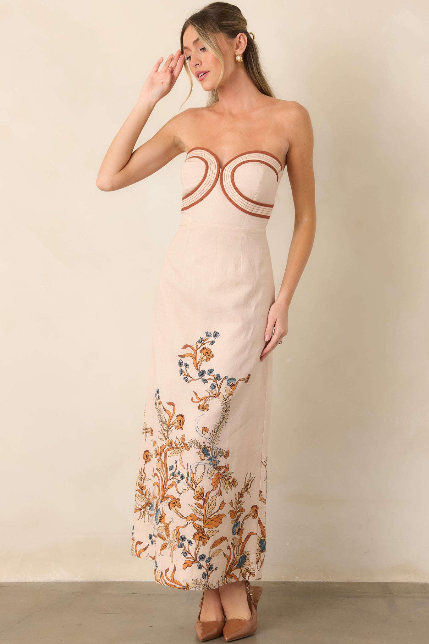 Breathable cotton-linen dress showcasing curved contrasting trim at the strapless neckline and a sleek floor-length column silhouette.