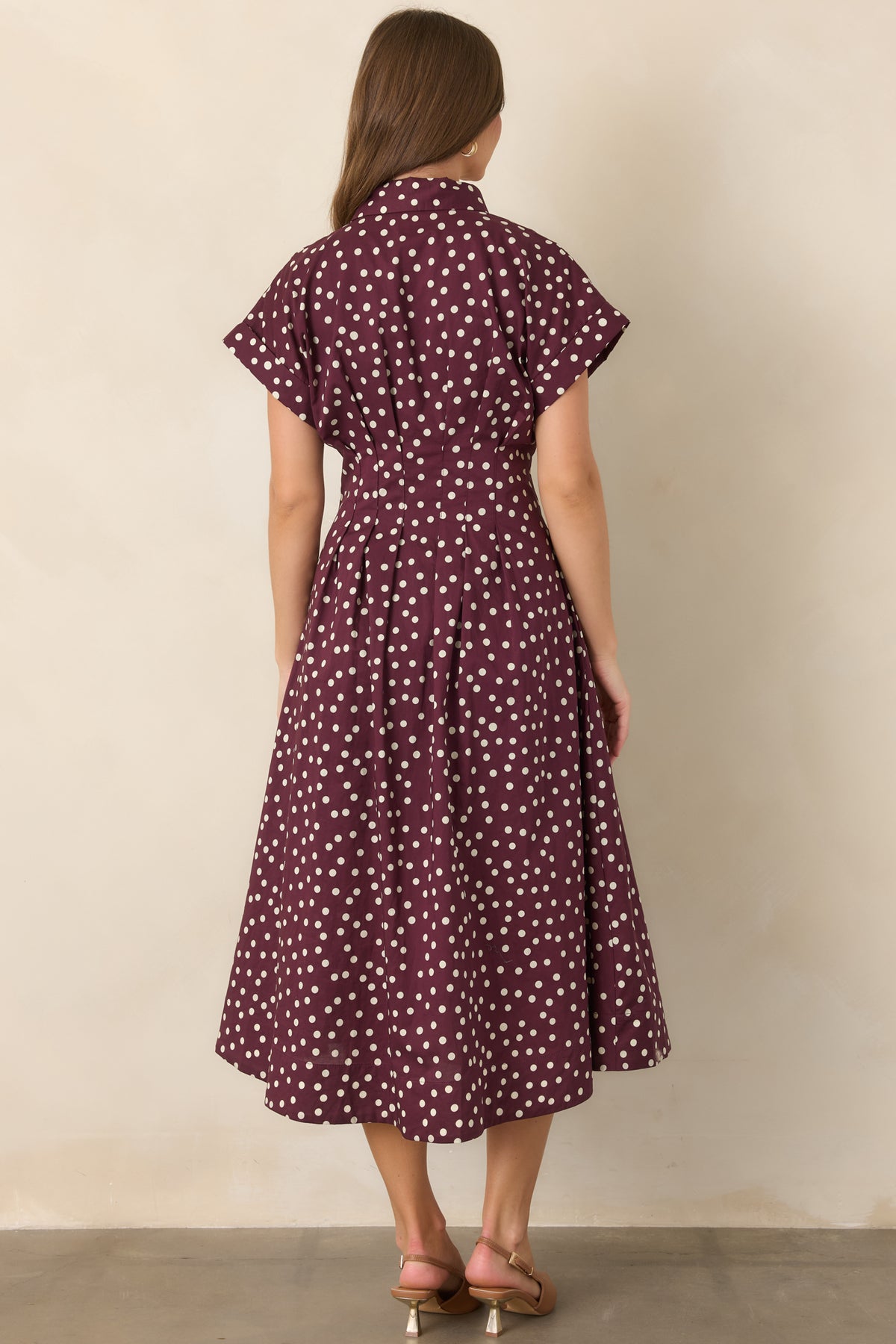 Rear view of the cotton midi dress featuring a defined waist, short sleeves, and flowing fit-and-flare skirt.