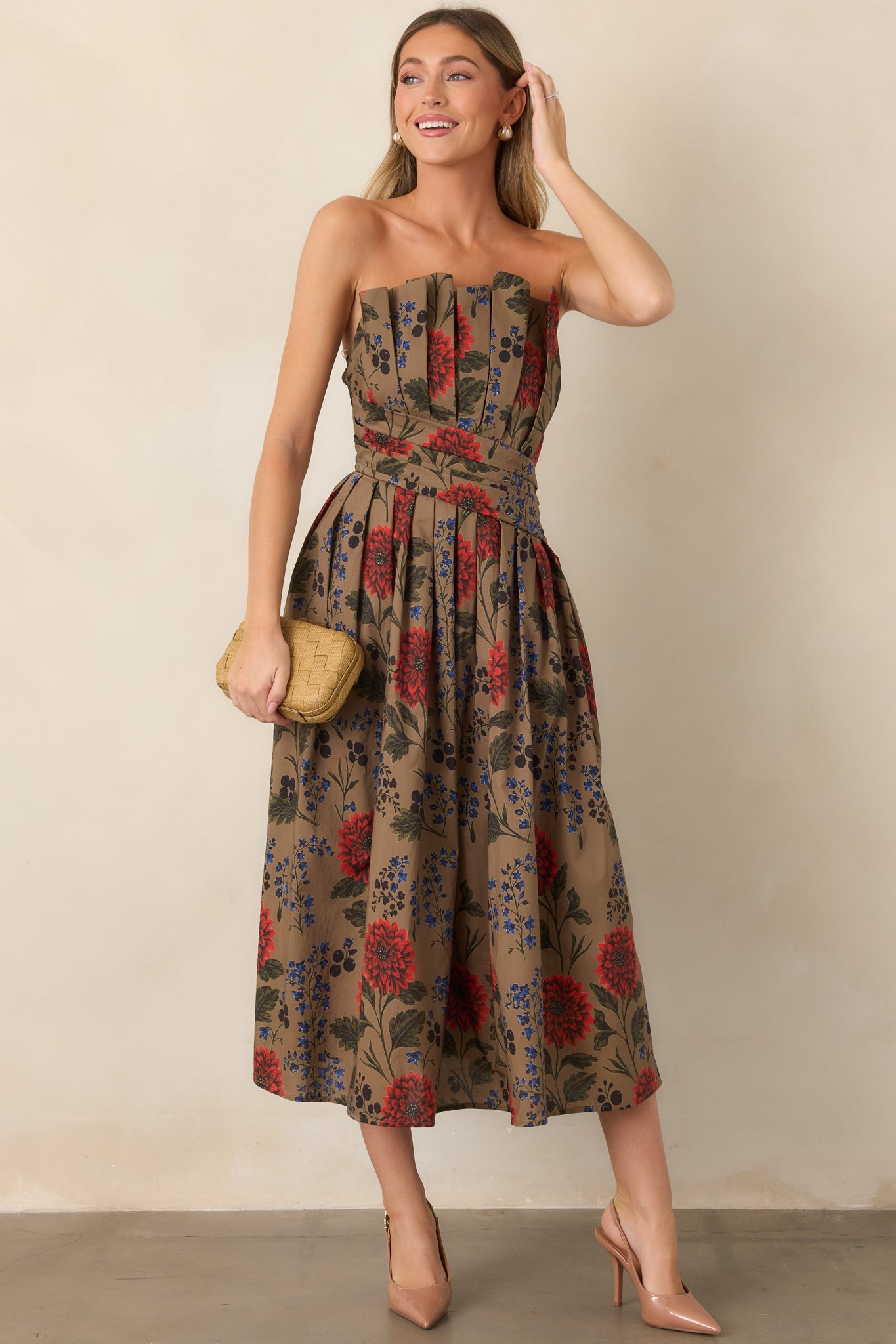 Full cotton midi dress showcasing a structured strapless bodice and flowing skirt decorated with vibrant red, cobalt blue, and olive botanical motifs.