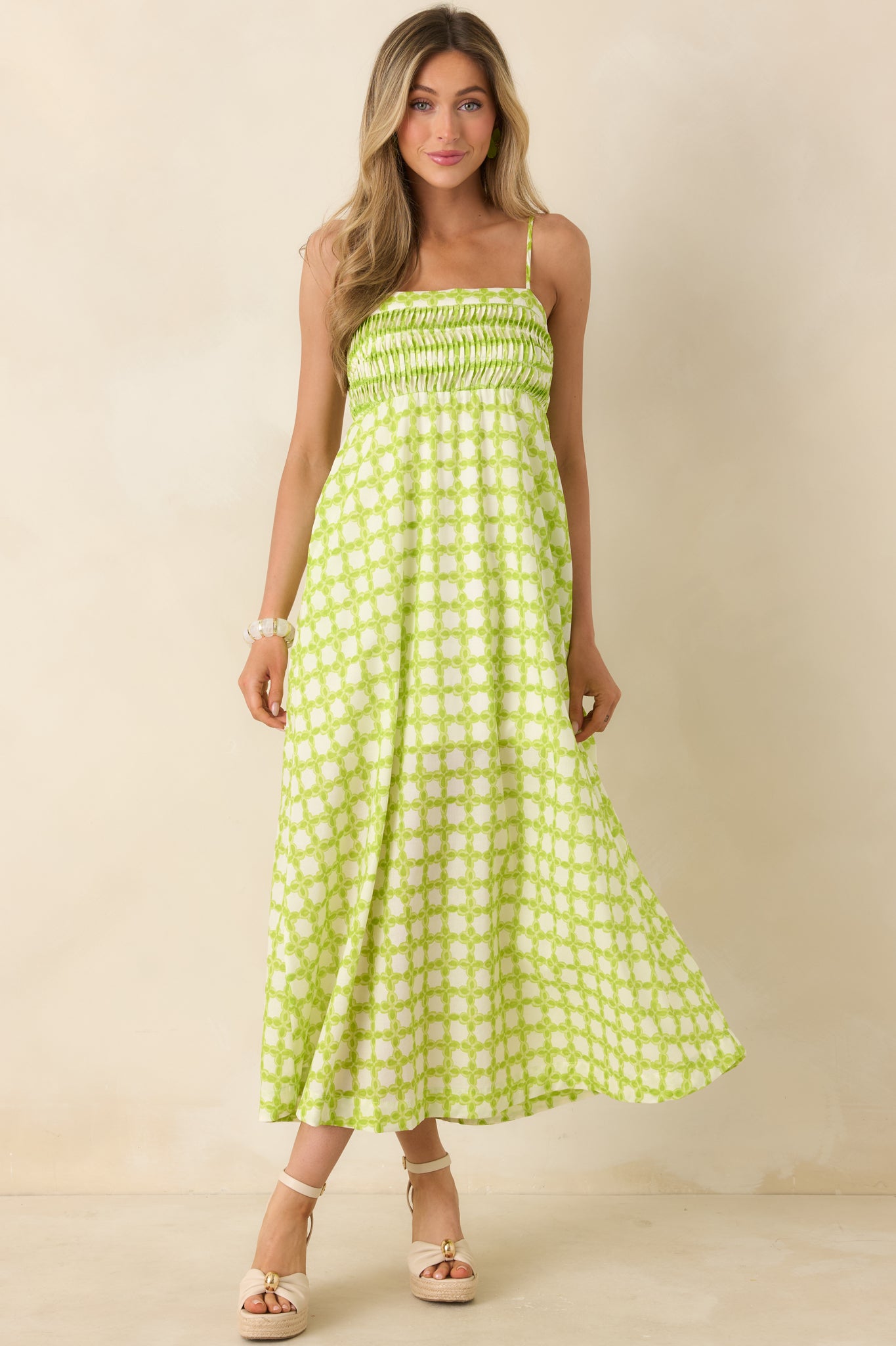 Cotton midi dress with a pleated bodice, smocked detailing, and a soft, flowy skirt.