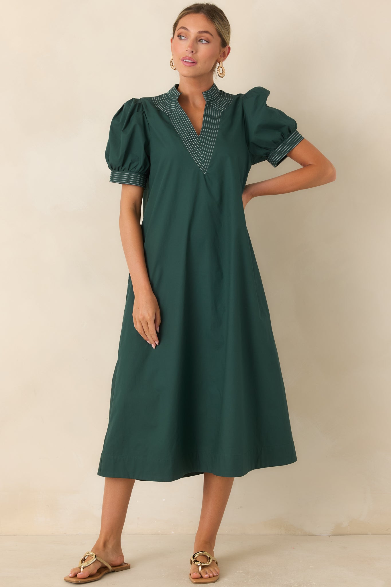 Midi dress crafted from 100% cotton with a structured neckline, side pockets, and an easy A-line shape.