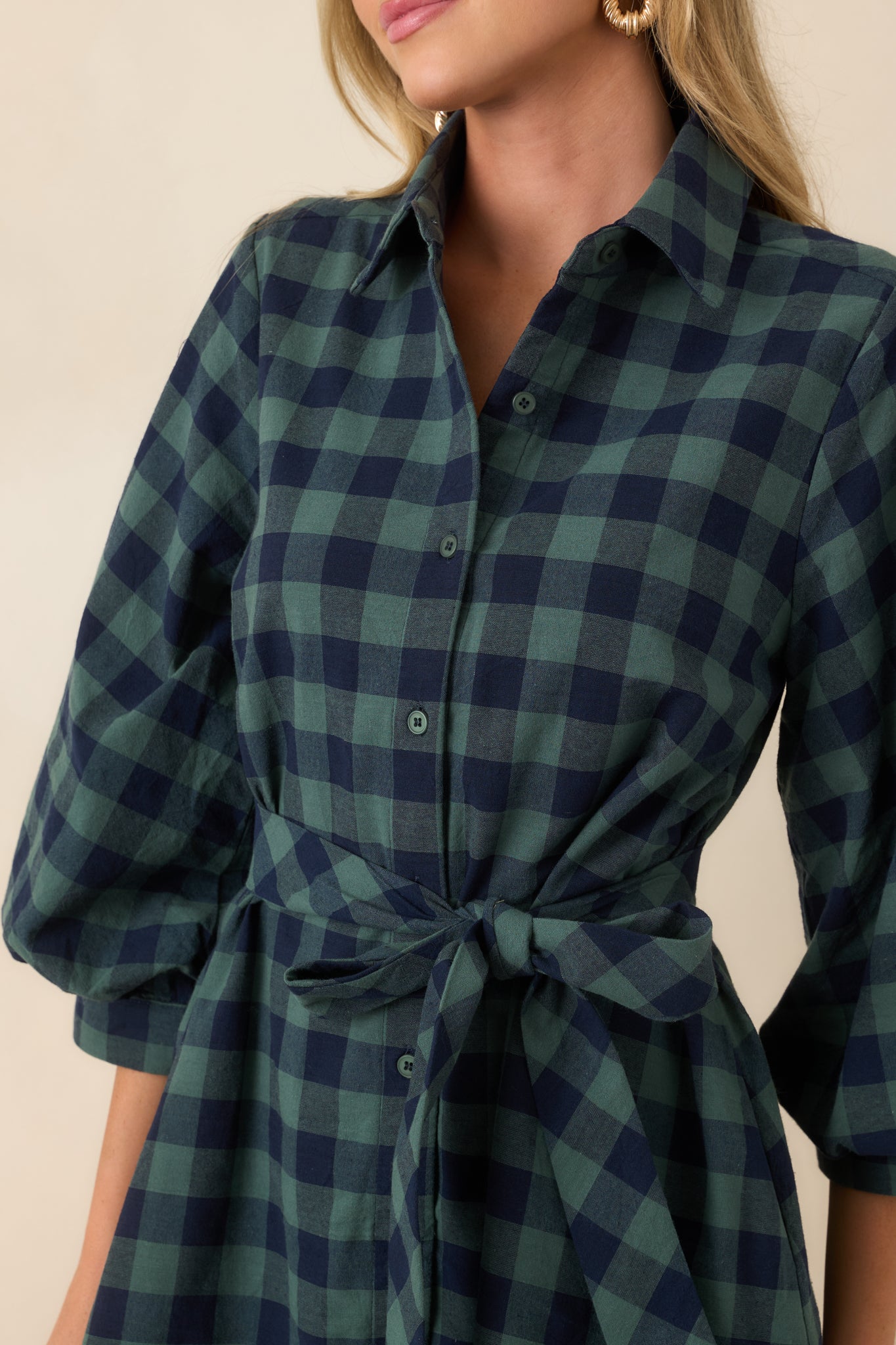 Close-up of the cotton mini dress highlighting the collared neckline, button-front closure, removable tie belt, and textured fabric.