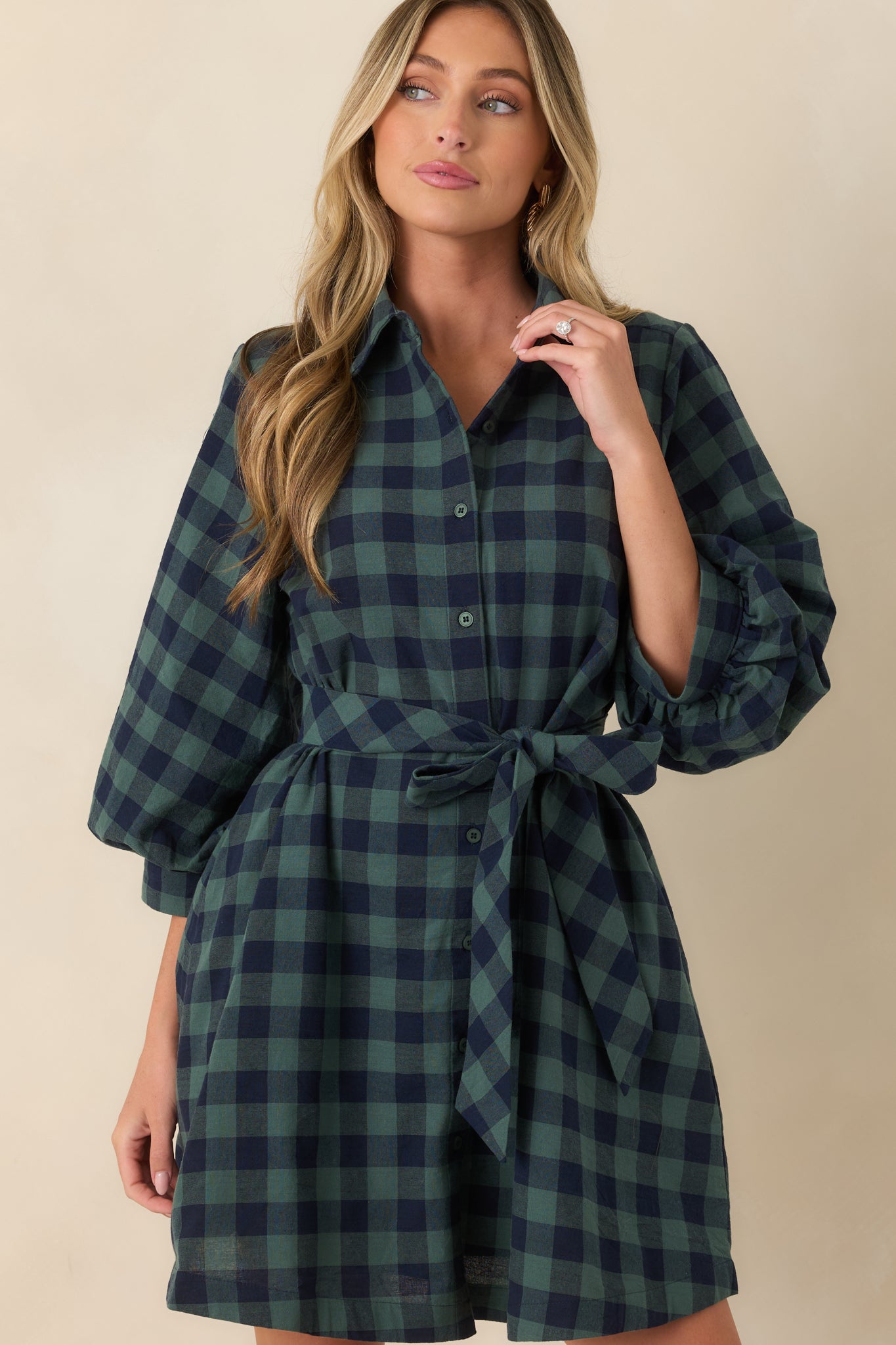 Close view of the cotton mini dress highlighting the collared neckline, functional button-front closure, and removable tie belt.