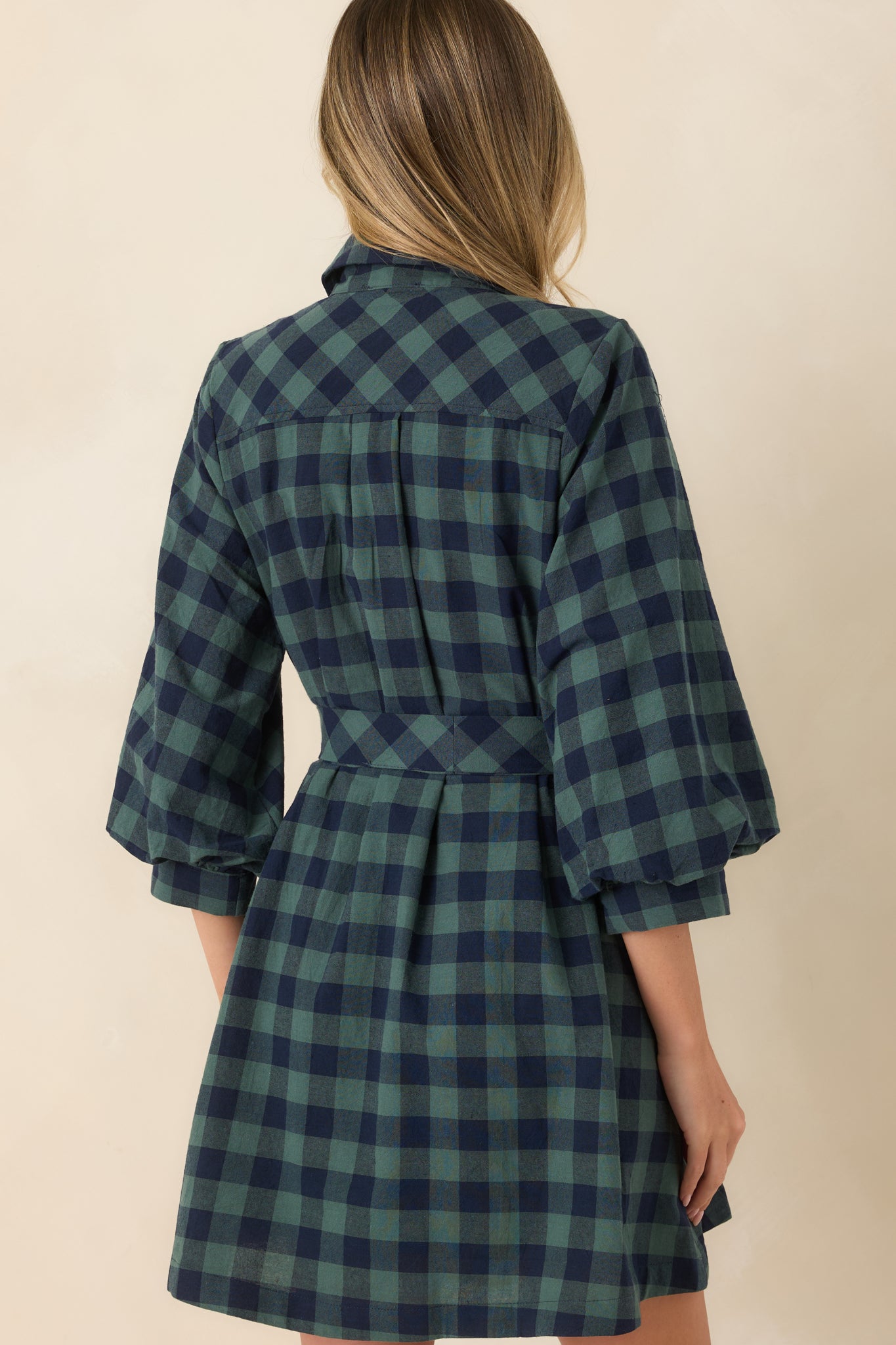 Rear view of the cotton mini dress featuring three-quarter balloon sleeves, a softly flared skirt, removable tie belt, and clean back silhouette.