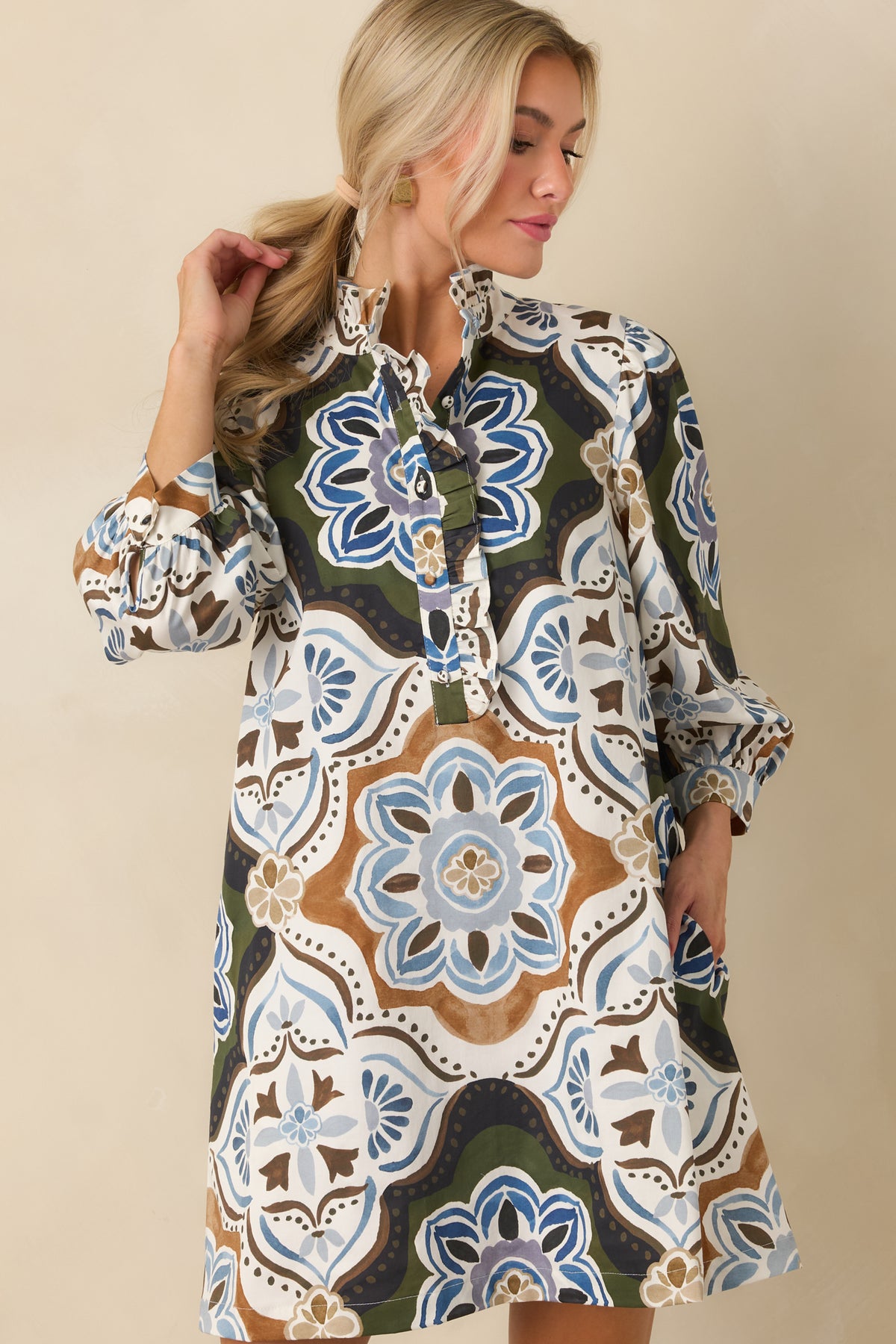 Cotton mini dress showcasing the ruffled stand collar and coordinating trim around the split neckline.