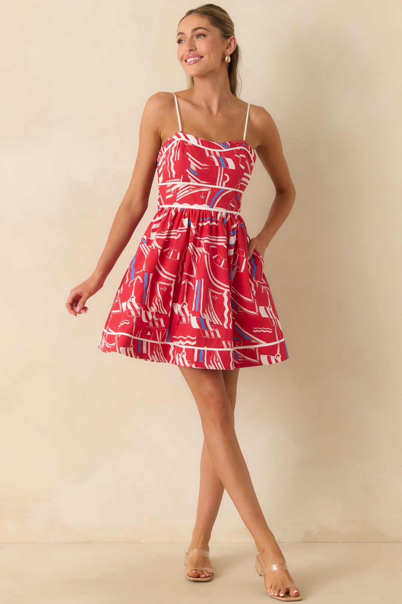 Cotton mini dress highlighting the fitted bodice, delicate straps, and charming self-tie bow accent.