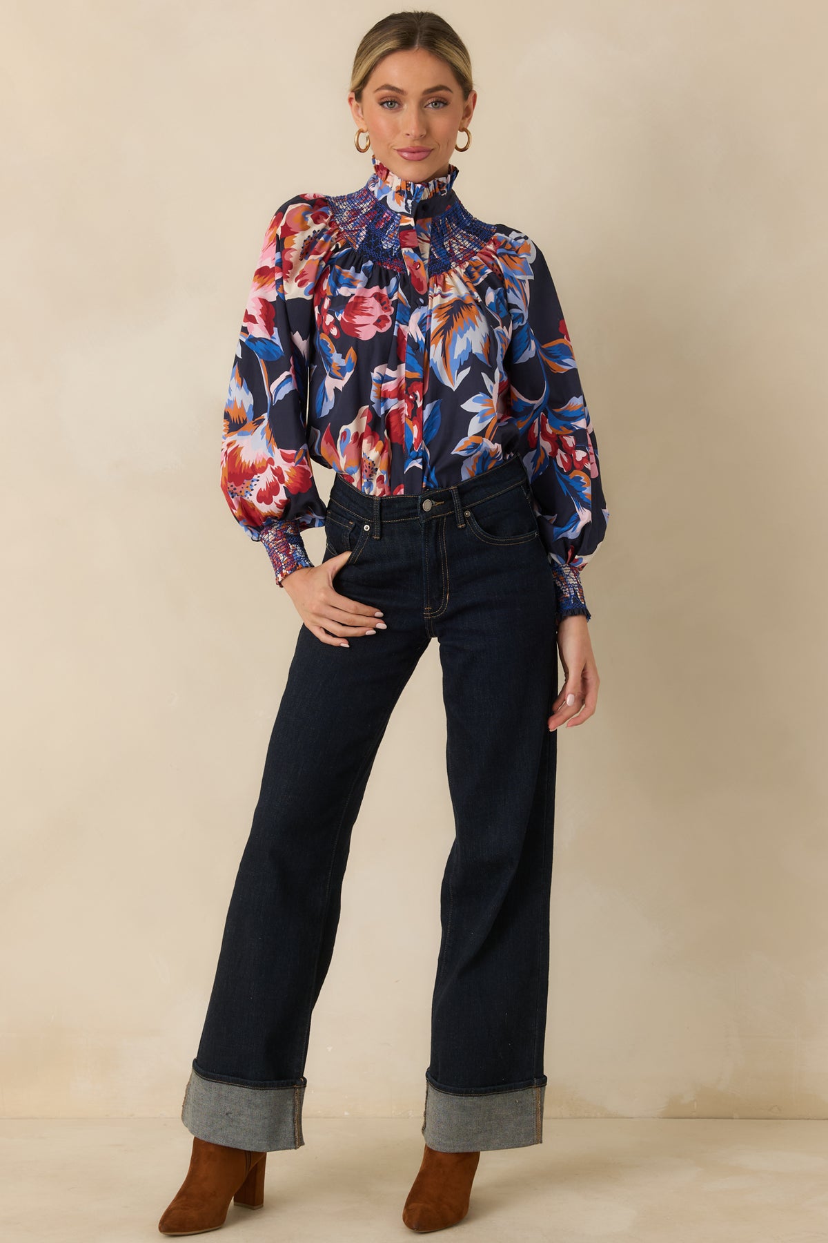 100% cotton top decorated with colorful oversized florals and a ruffled stand collar above the button-front design.
