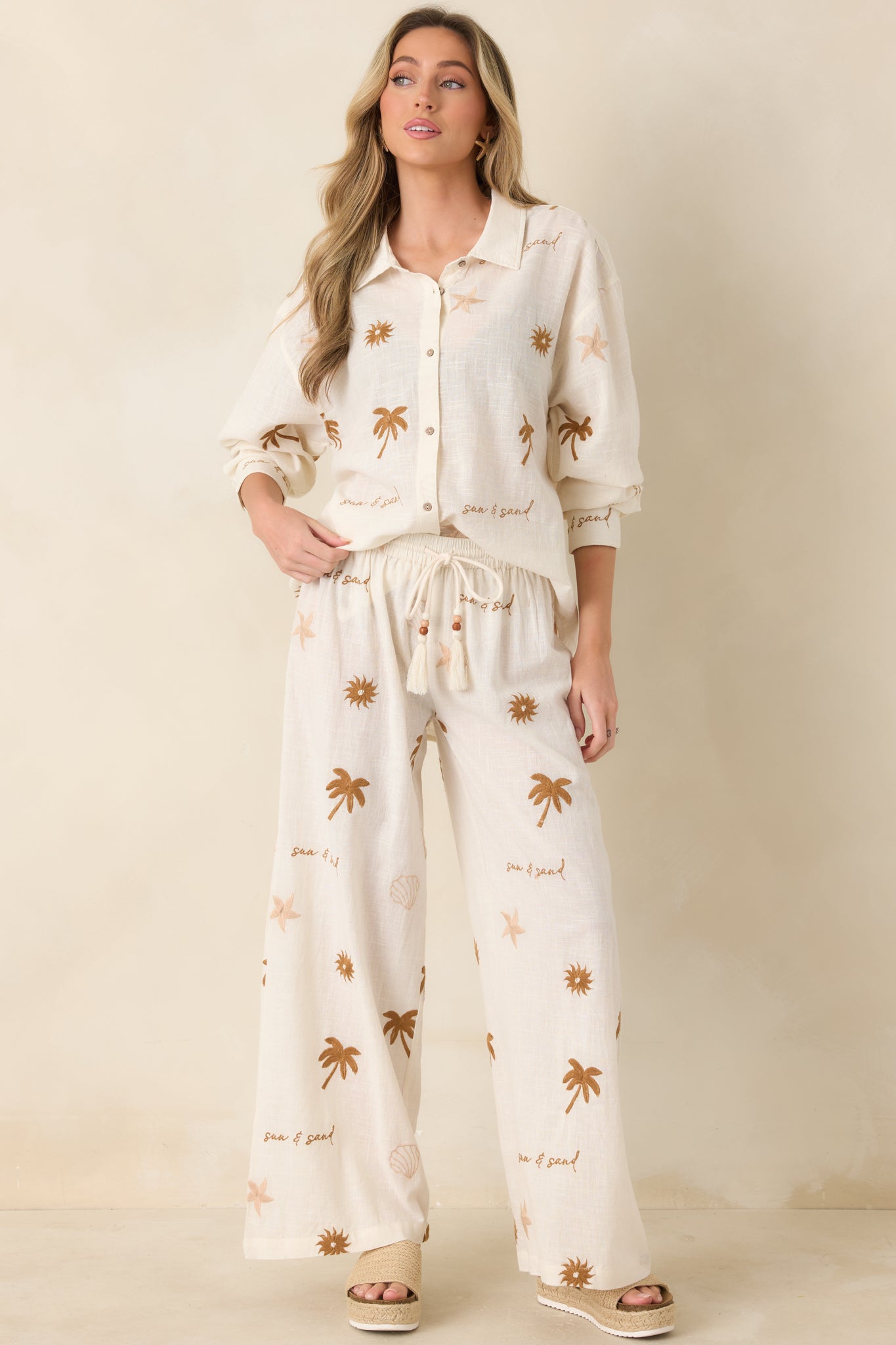 Cotton pants with comfortable elastic waist, subtle beads, and flowing leg design.