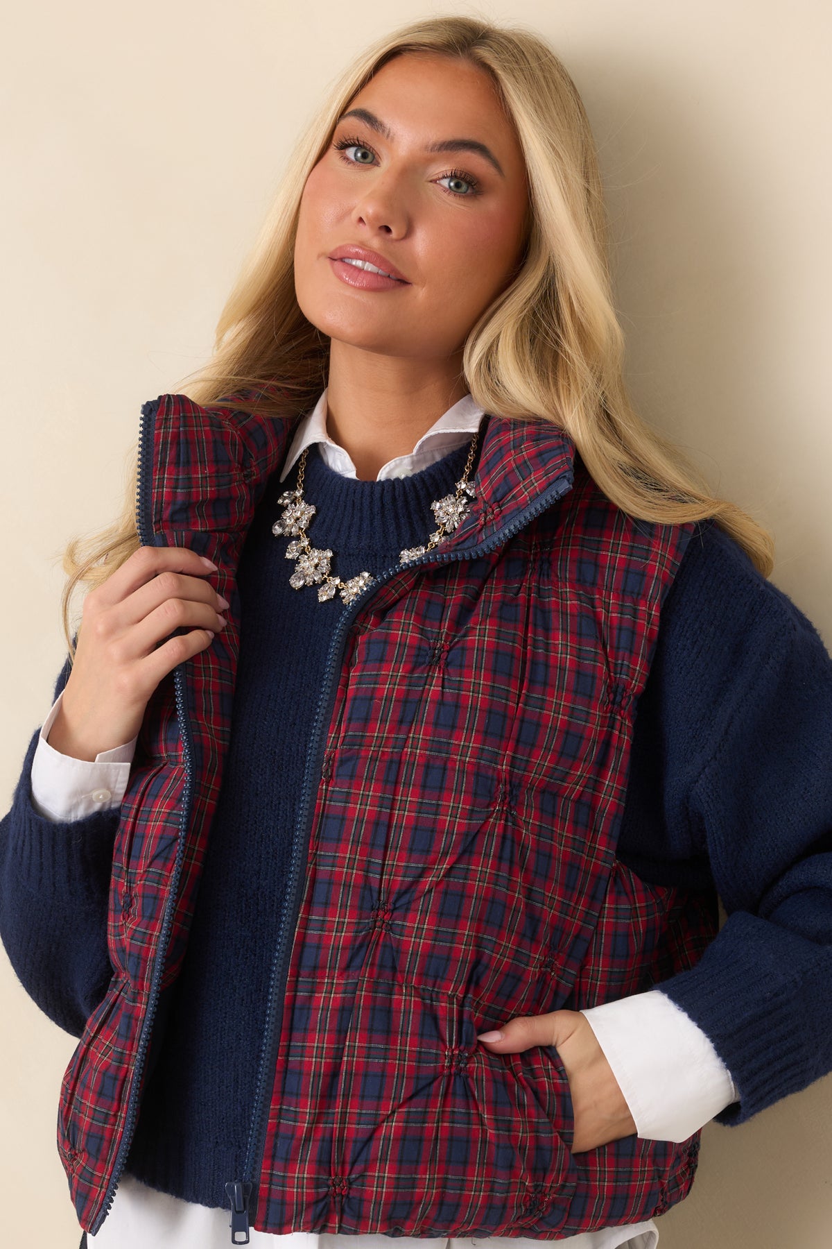 Side pocket opening and plaid pattern on the cotton quilted vest.