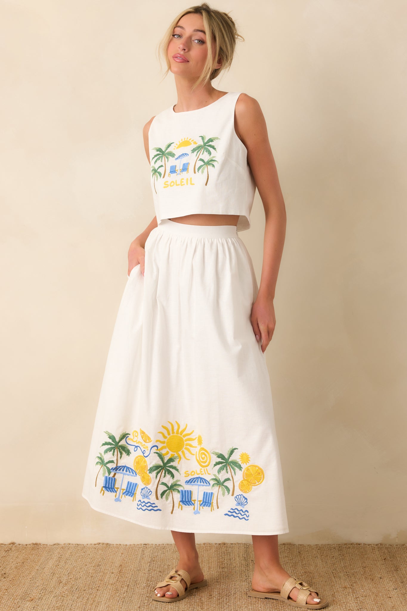Full view of the cotton blend skirt showcasing a relaxed midi length, elastic waistband, and colorful embroidery that wraps the hemline.