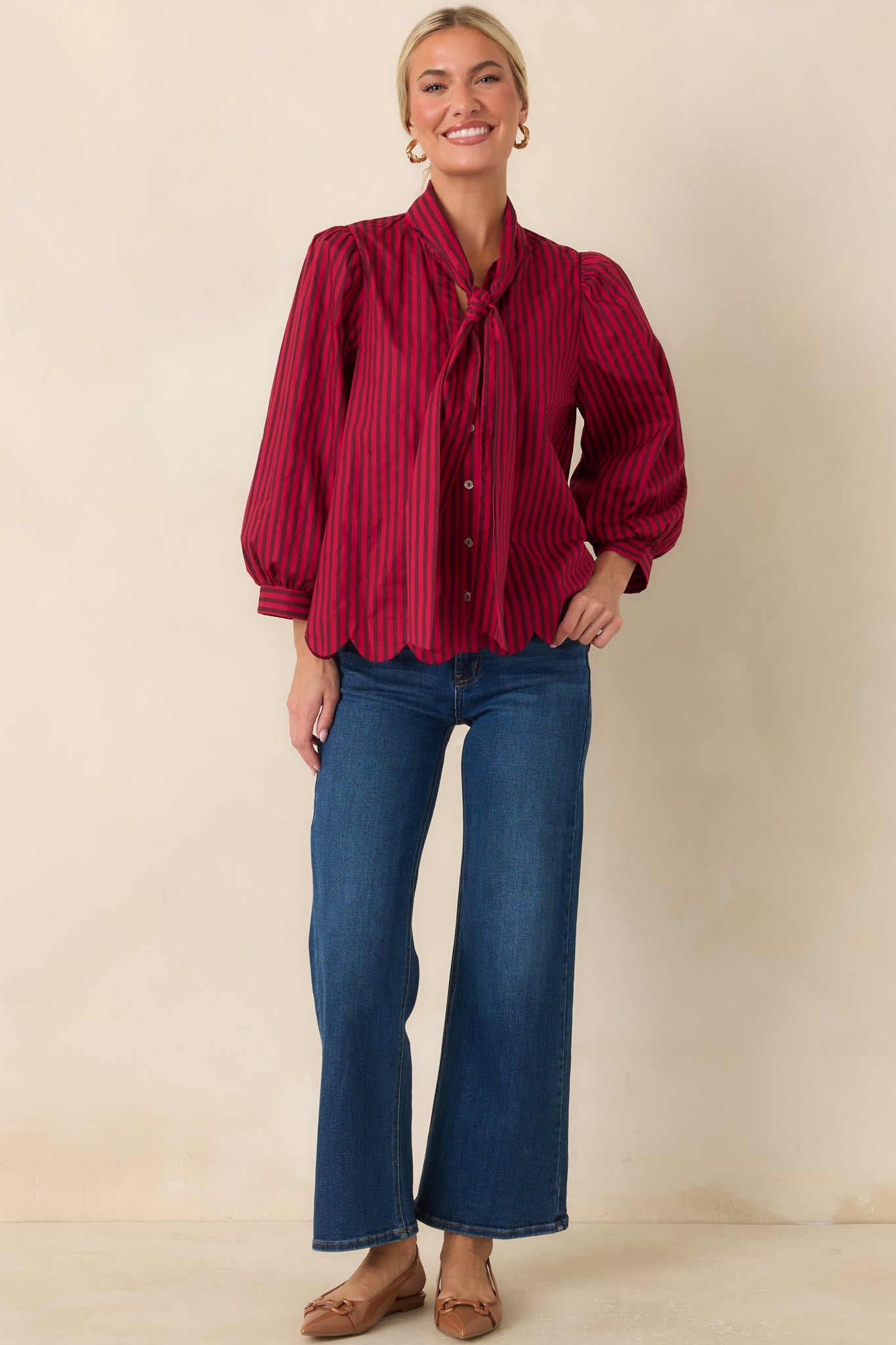 100% cotton striped blouse with a button-front design, voluminous 3/4 sleeves, and a feminine scalloped hem finish.
