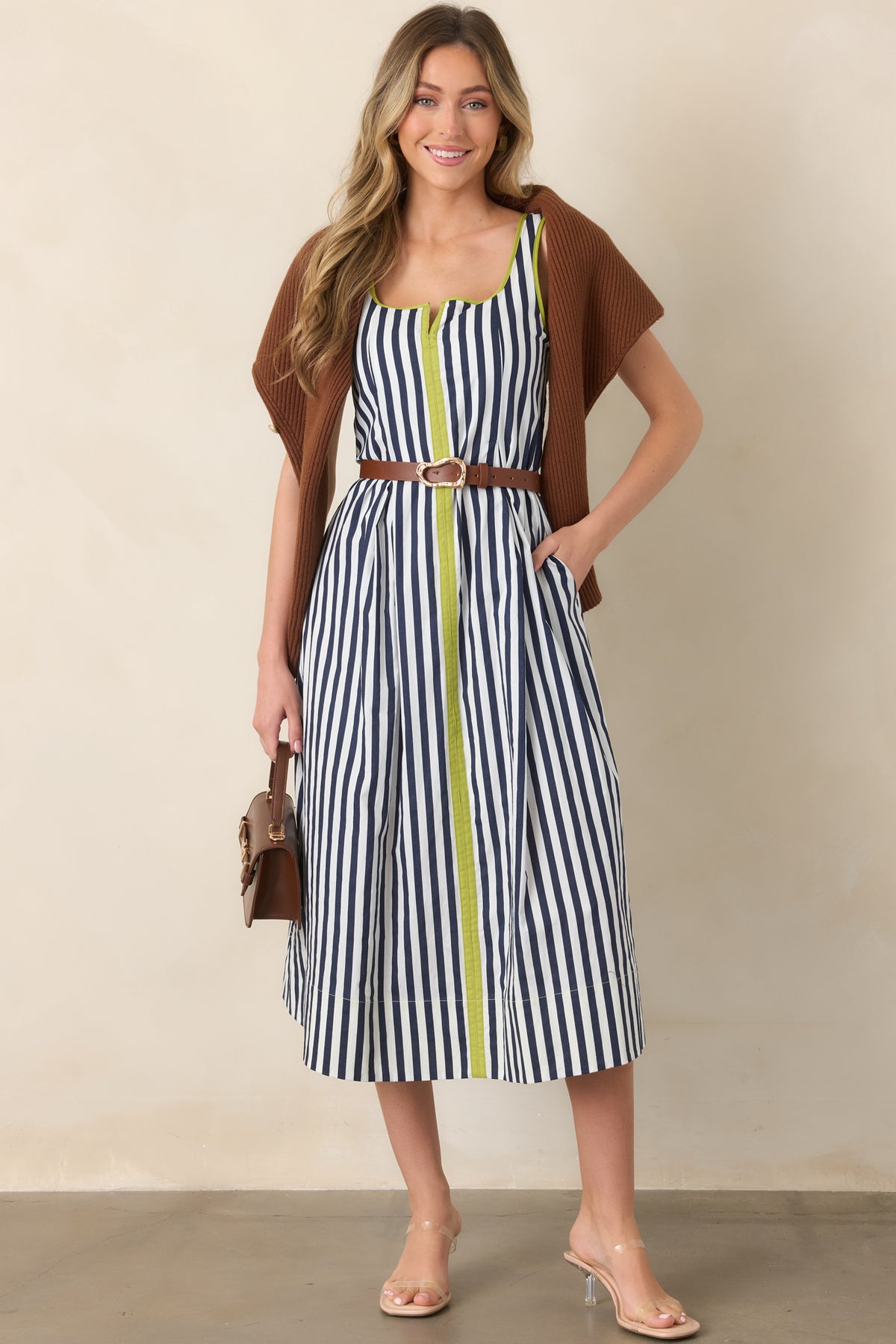 Breathable cotton midi dress showcasing timeless navy and ivory stripes, contrasting chartreuse accents, and a relaxed polished silhouette.