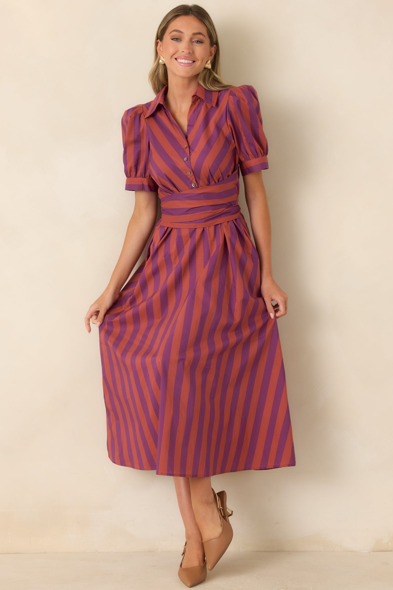 Soft cotton midi dress with alternating striped panels, gently puffed sleeves, and a wide tie sash at the waist. 