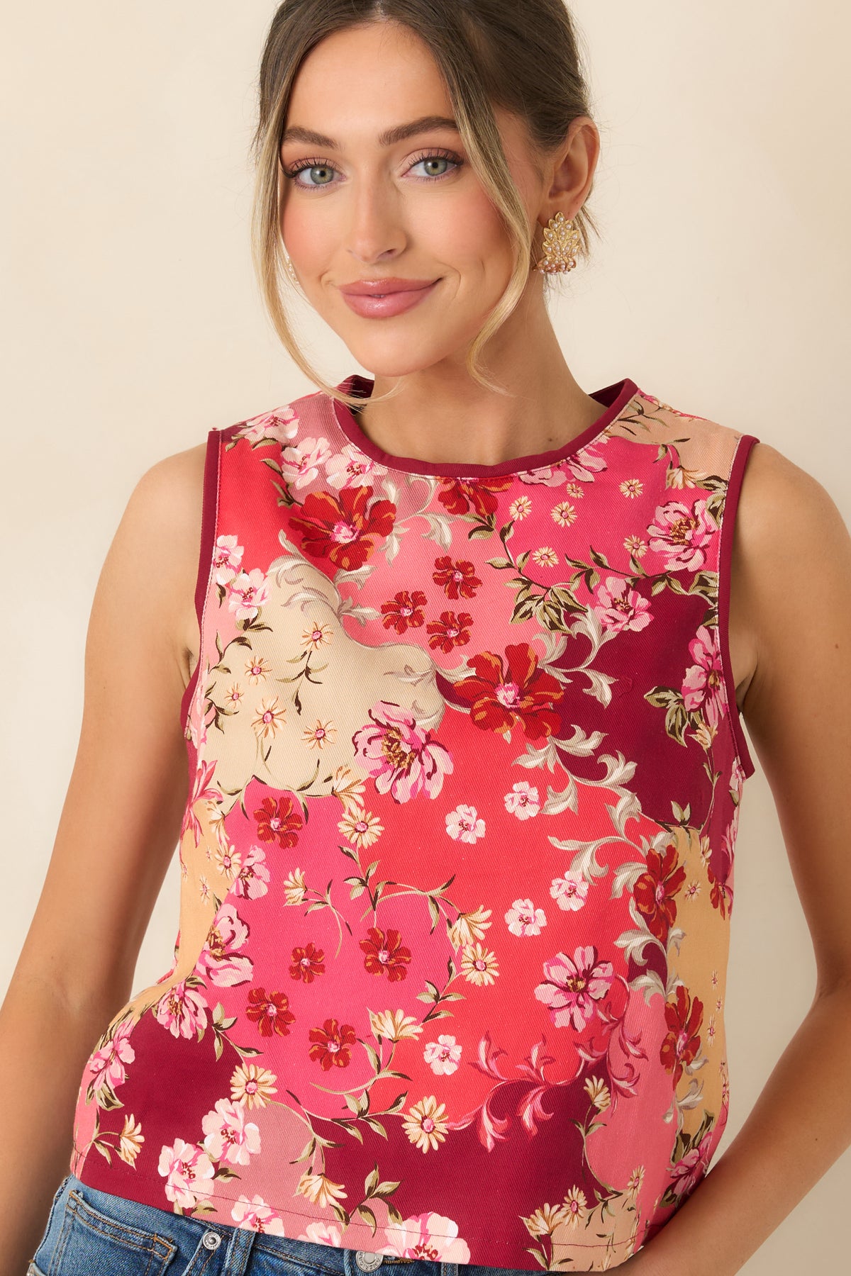 Pink, burgundy, peach, and cream flowers scatter across the cotton top among delicate green leafy accents.