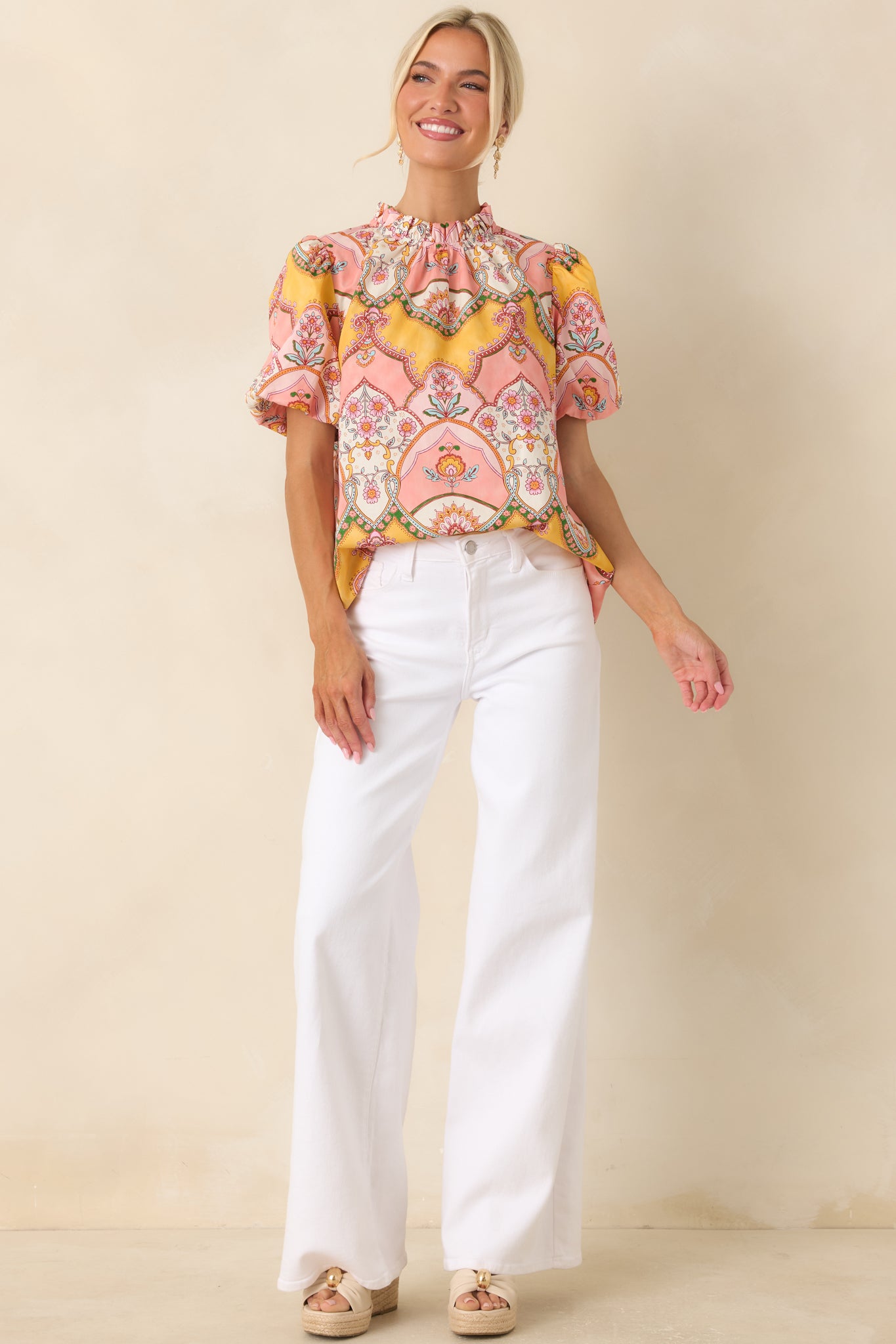 Pink and marigold cotton top with a relaxed fit, short bubble sleeves, and an eye-catching scarf-print pattern inspired by classic decorative motifs.