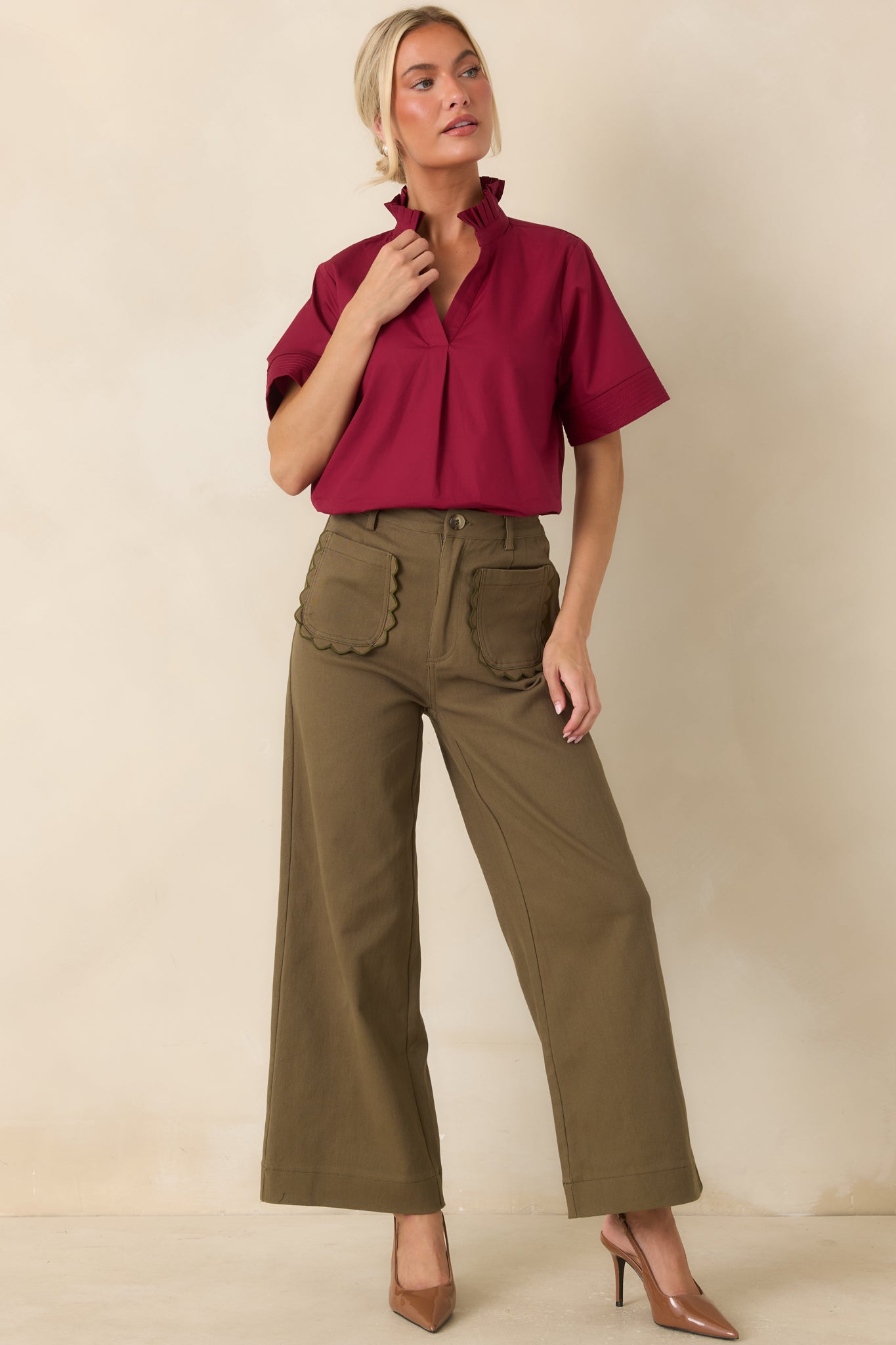 Cotton top featuring a softly pleated ruffle collar, split neckline, short sleeves, and a polished relaxed silhouette.