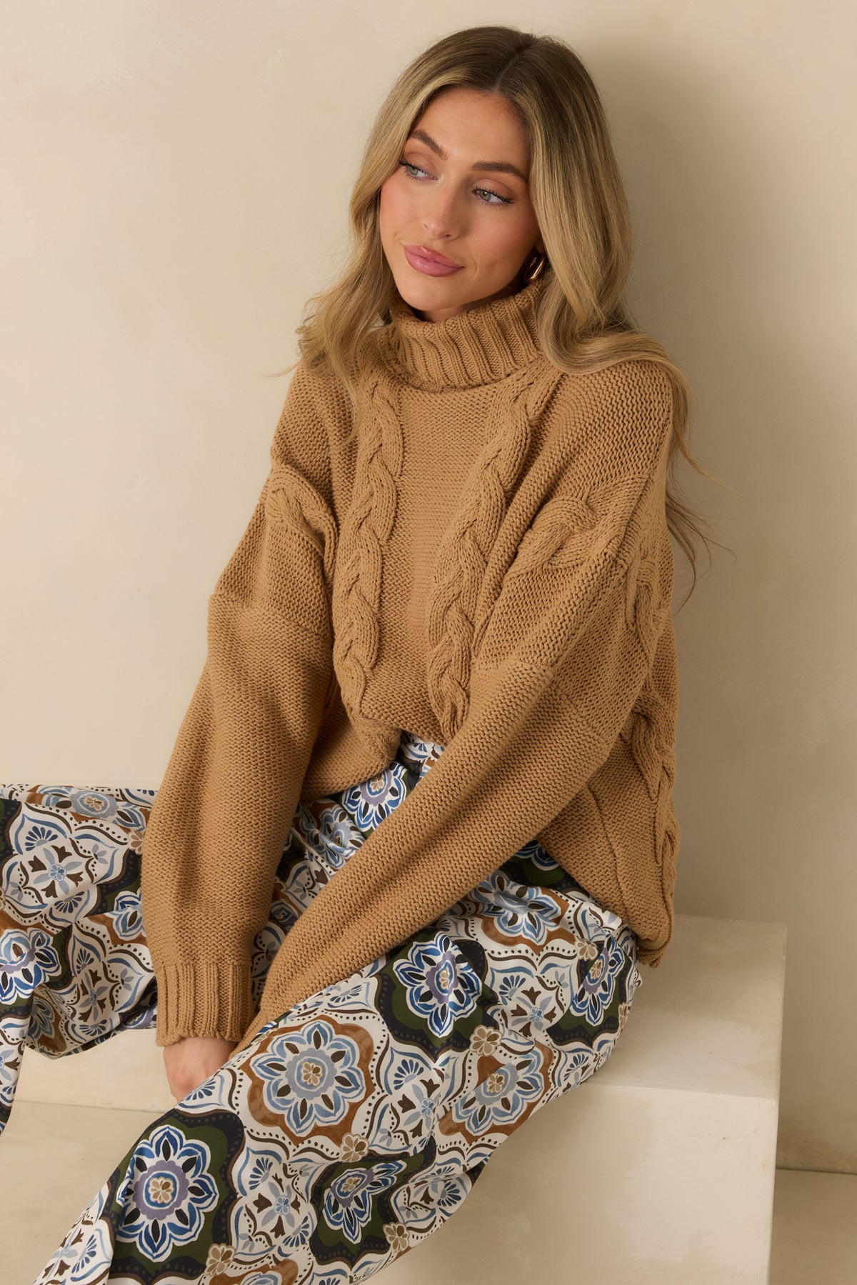 Cozy cotton-blend knit showcasing intricate cable detailing and a dropped shoulder with a relaxed long sleeve.