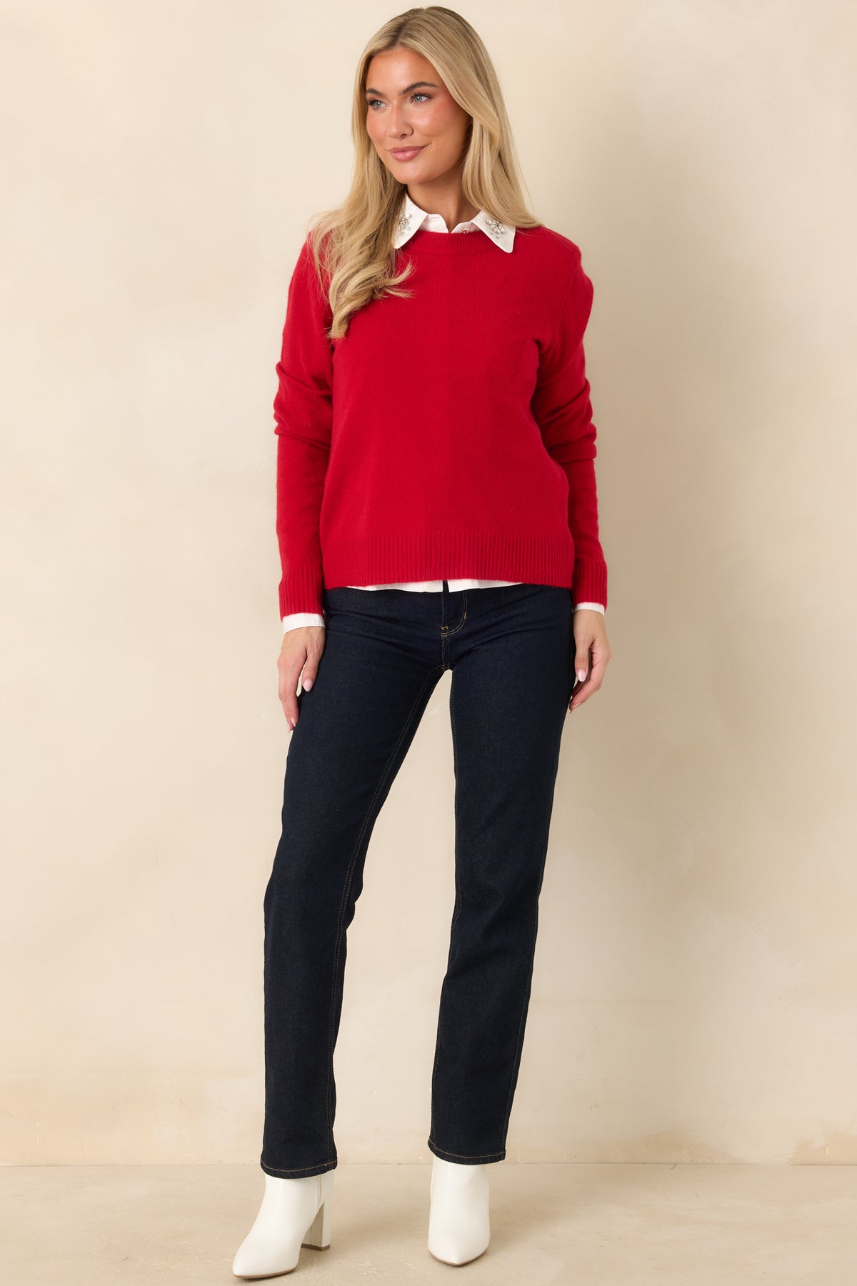 Cozy red sweater with long sleeves, a rounded neckline, and ribbed edging.
