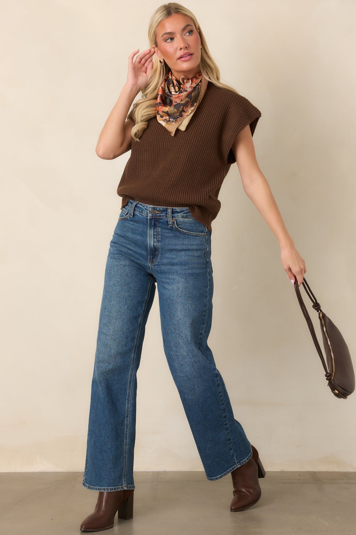 Cozy knit top showcasing a structured mock neckline, relaxed shape, and wide ribbed hem for subtle waist definition.