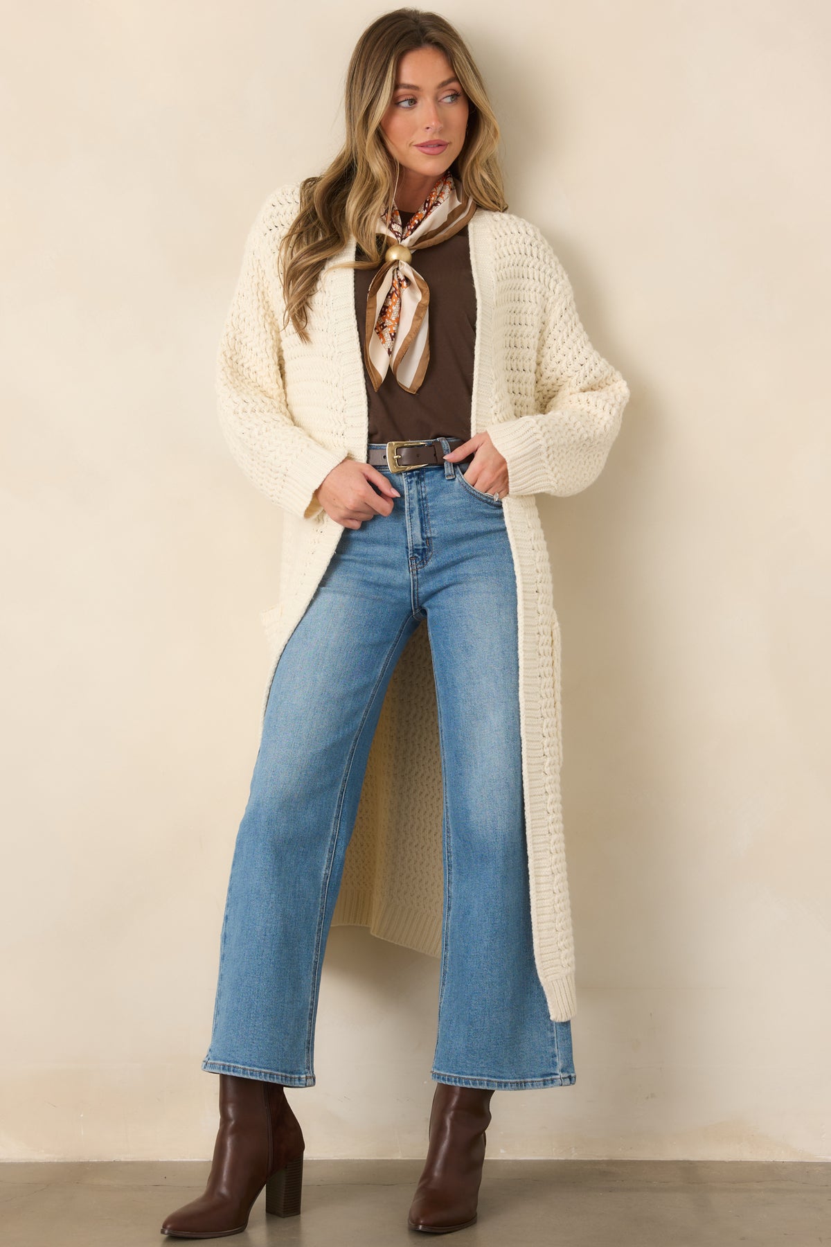 Cream chunky knit duster cardigan featuring a relaxed open front, long sleeves, ribbed cuffs, and an elongated silhouette.