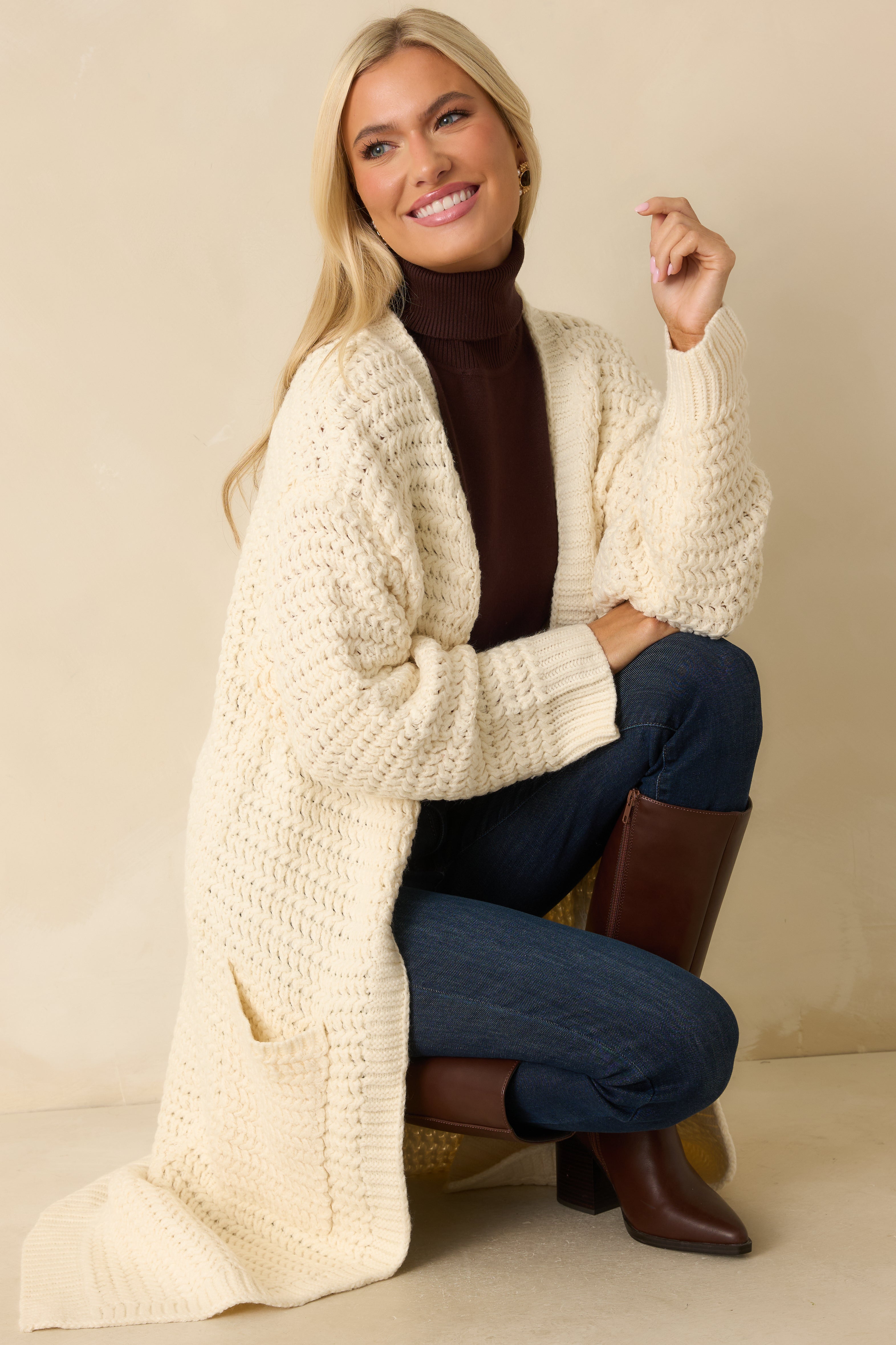 Full view of the cream duster cardigan showing the longline silhouette, open front, and relaxed fit with soft drape.